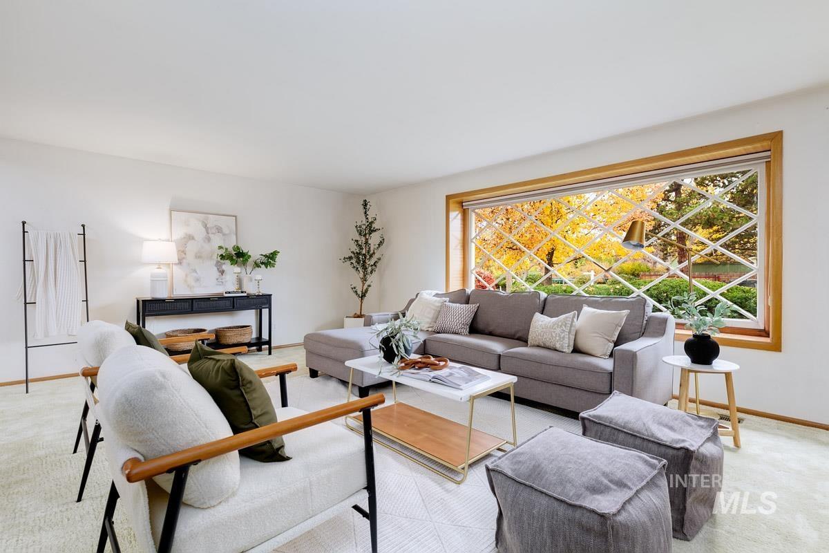 Living room with light colored carpet and baseboards