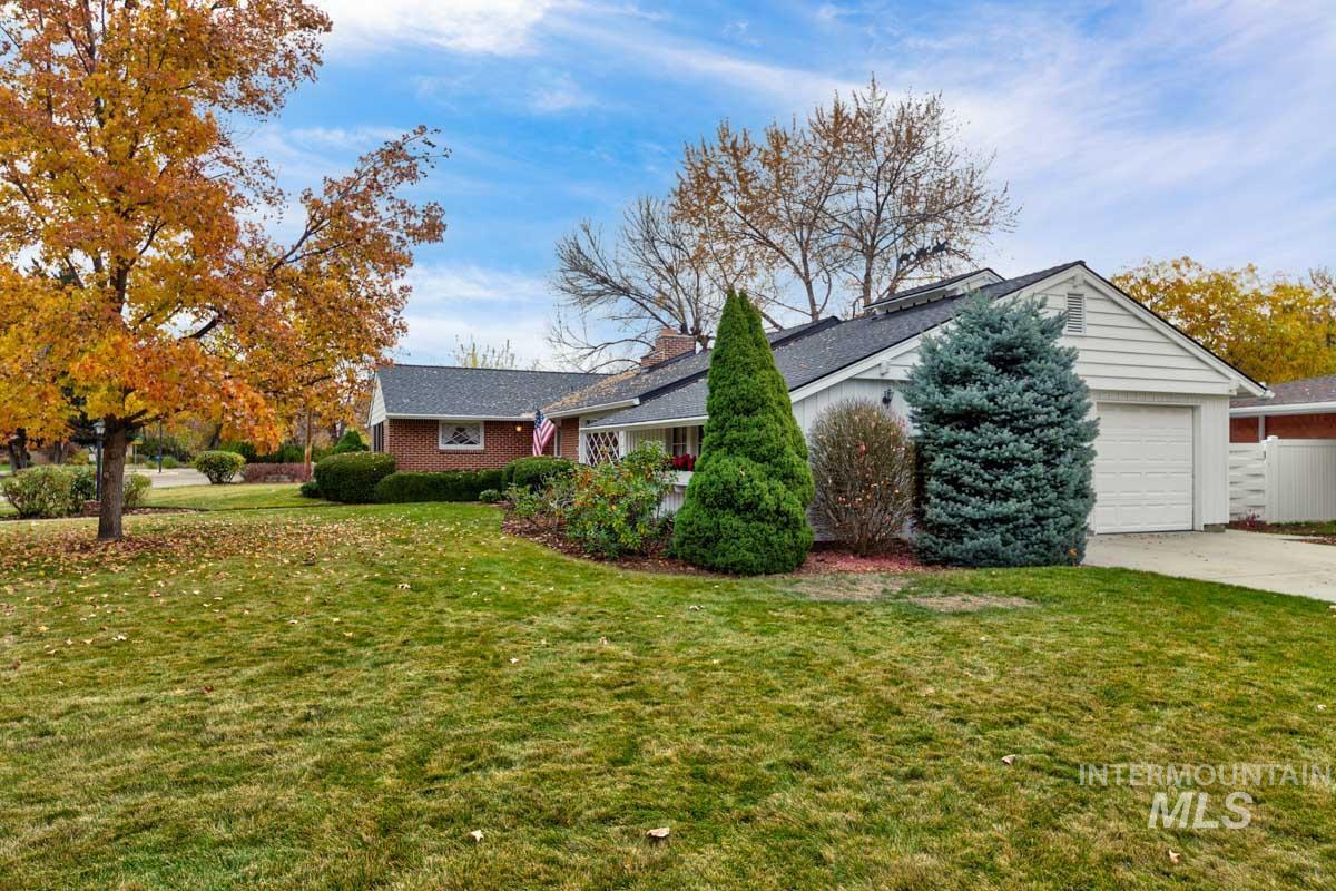 View of front of house with a front lawn, a garage, and concrete driveway
