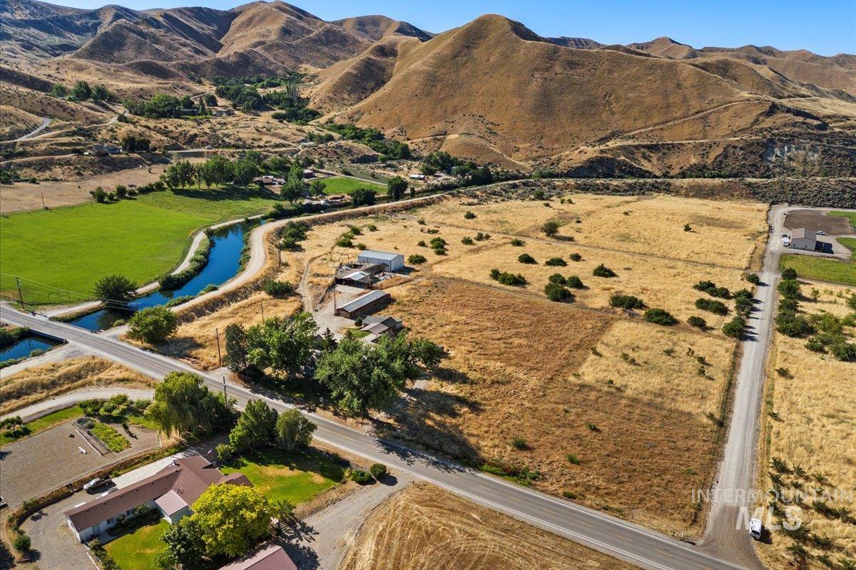 Aerial view of property and surrounding area featuring a water and mountain view and rural landscape