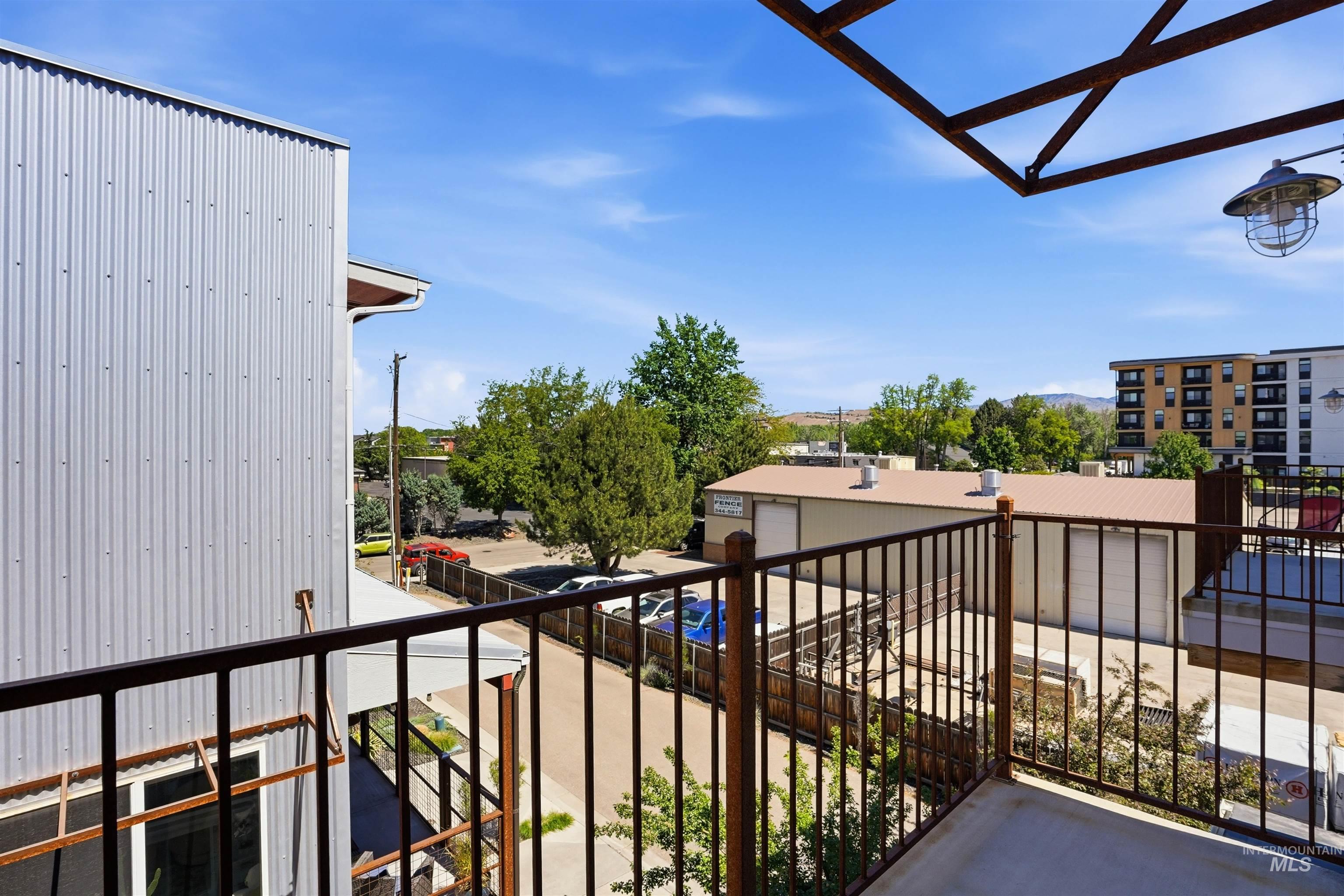 Private balcony featuring metal railings and a concrete surface