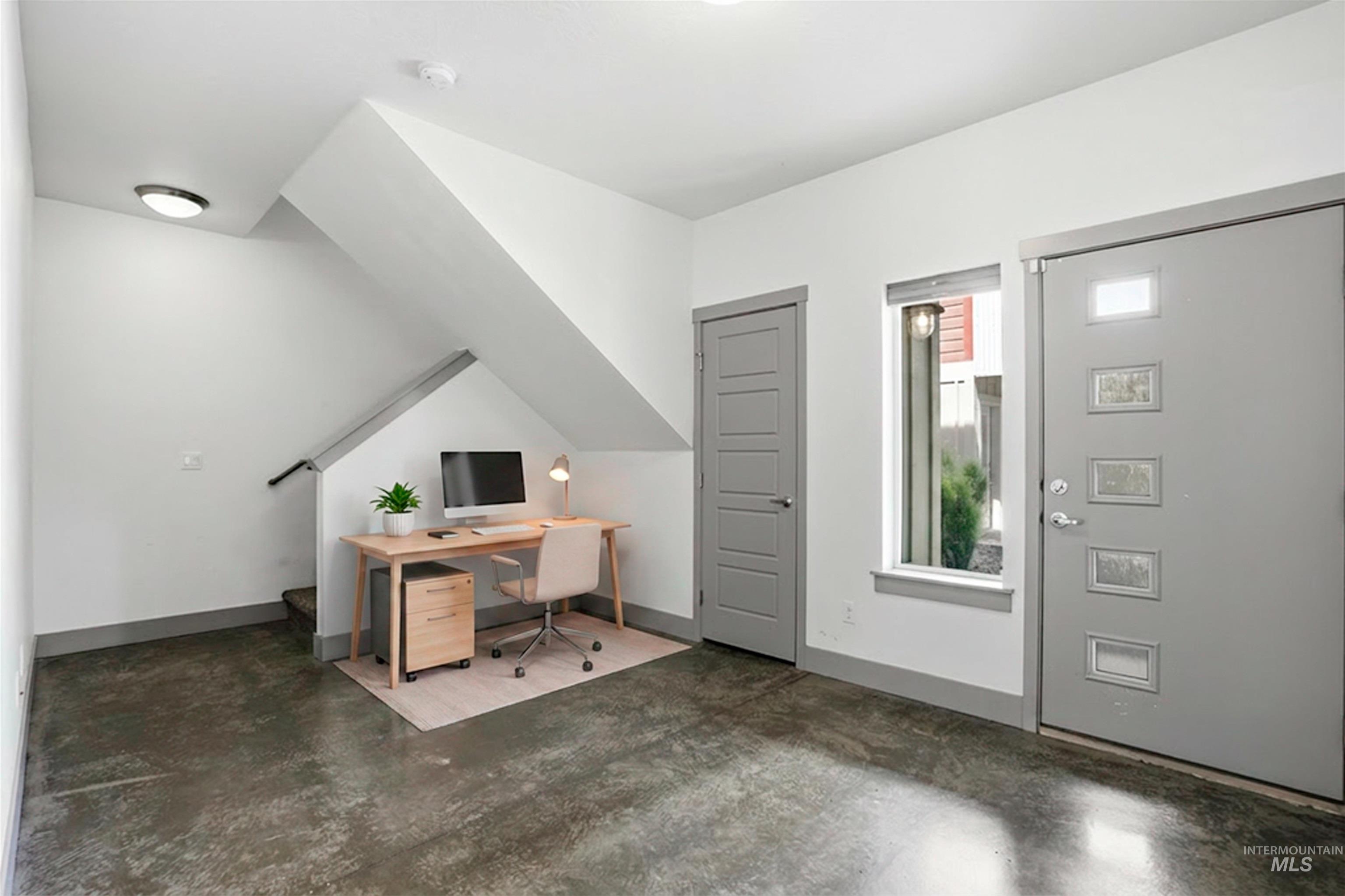 Entryway featuring polished concrete flooring, a modern panel door, and a full-light window