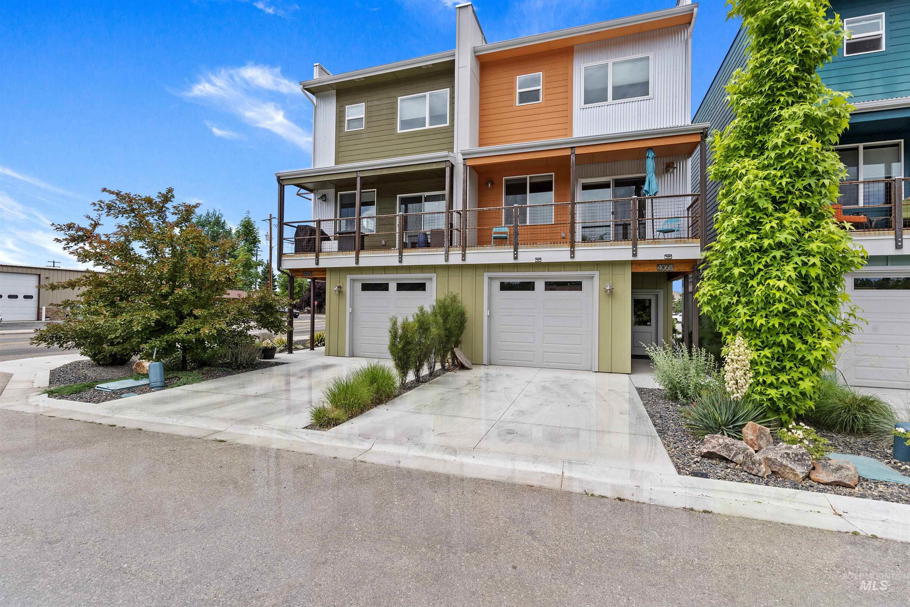 Contemporary multi-level townhome featuring a private balcony with cable railings