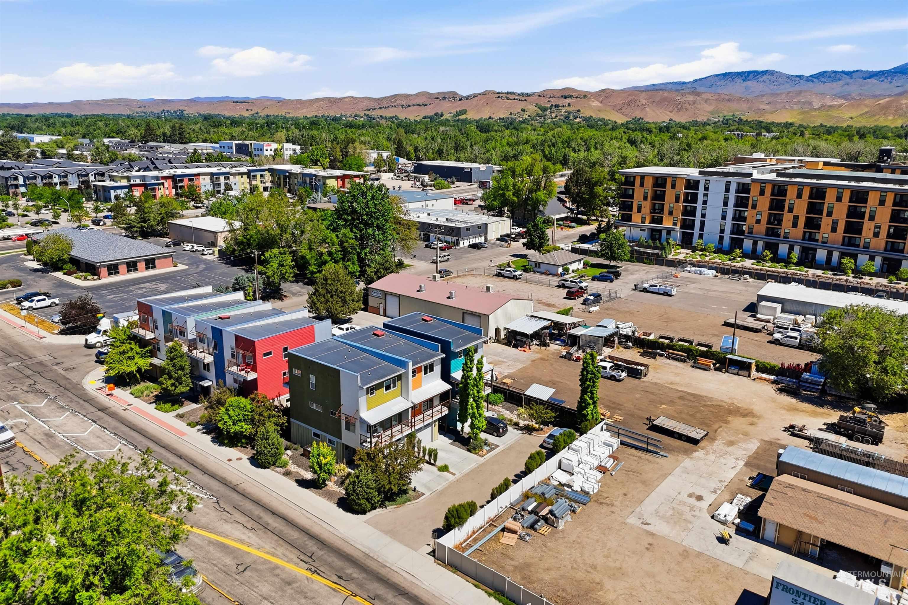 Modern townhomes featuring varied exterior colors and rooftop solar panels
