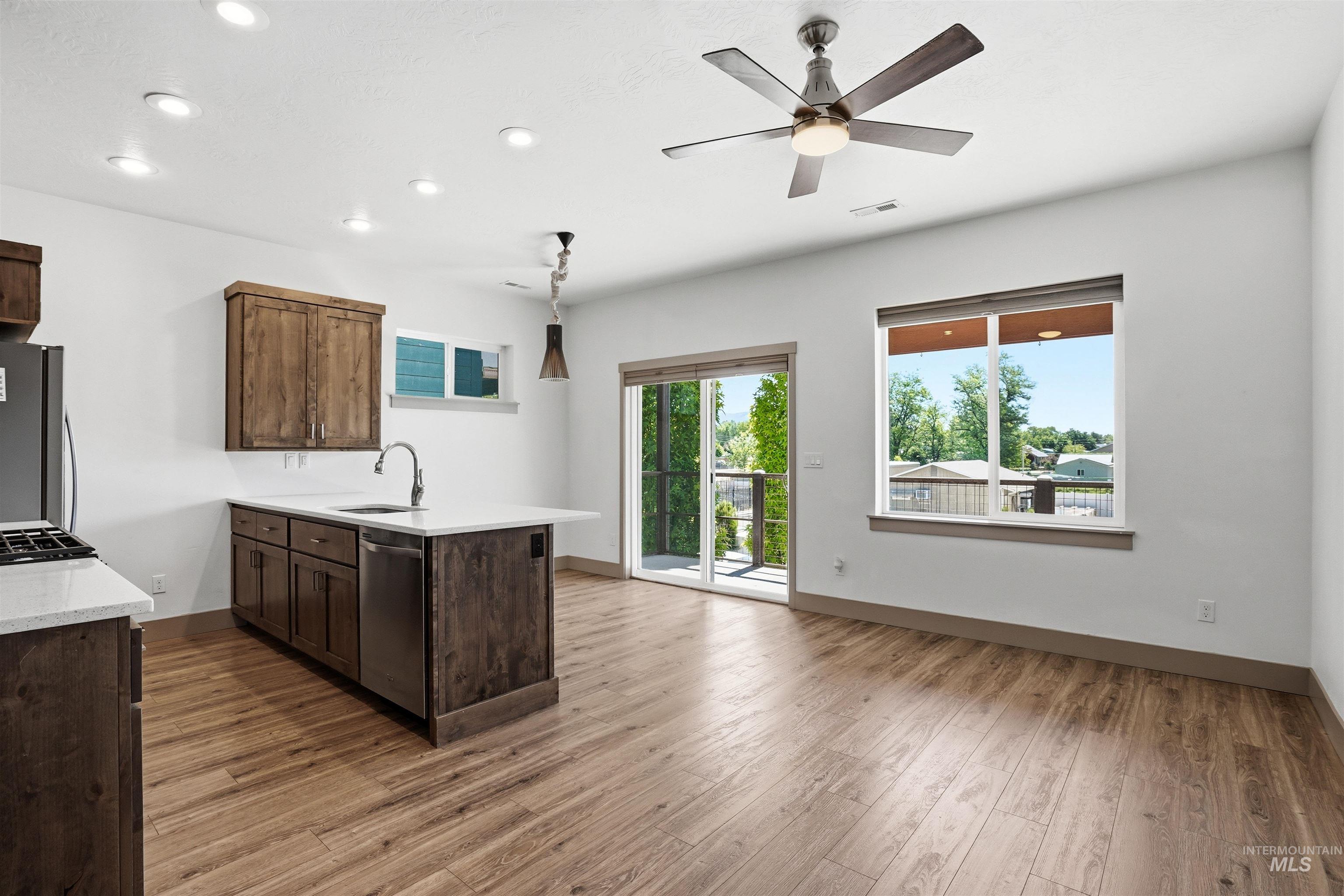 Open-concept living space with wood-finish flooring