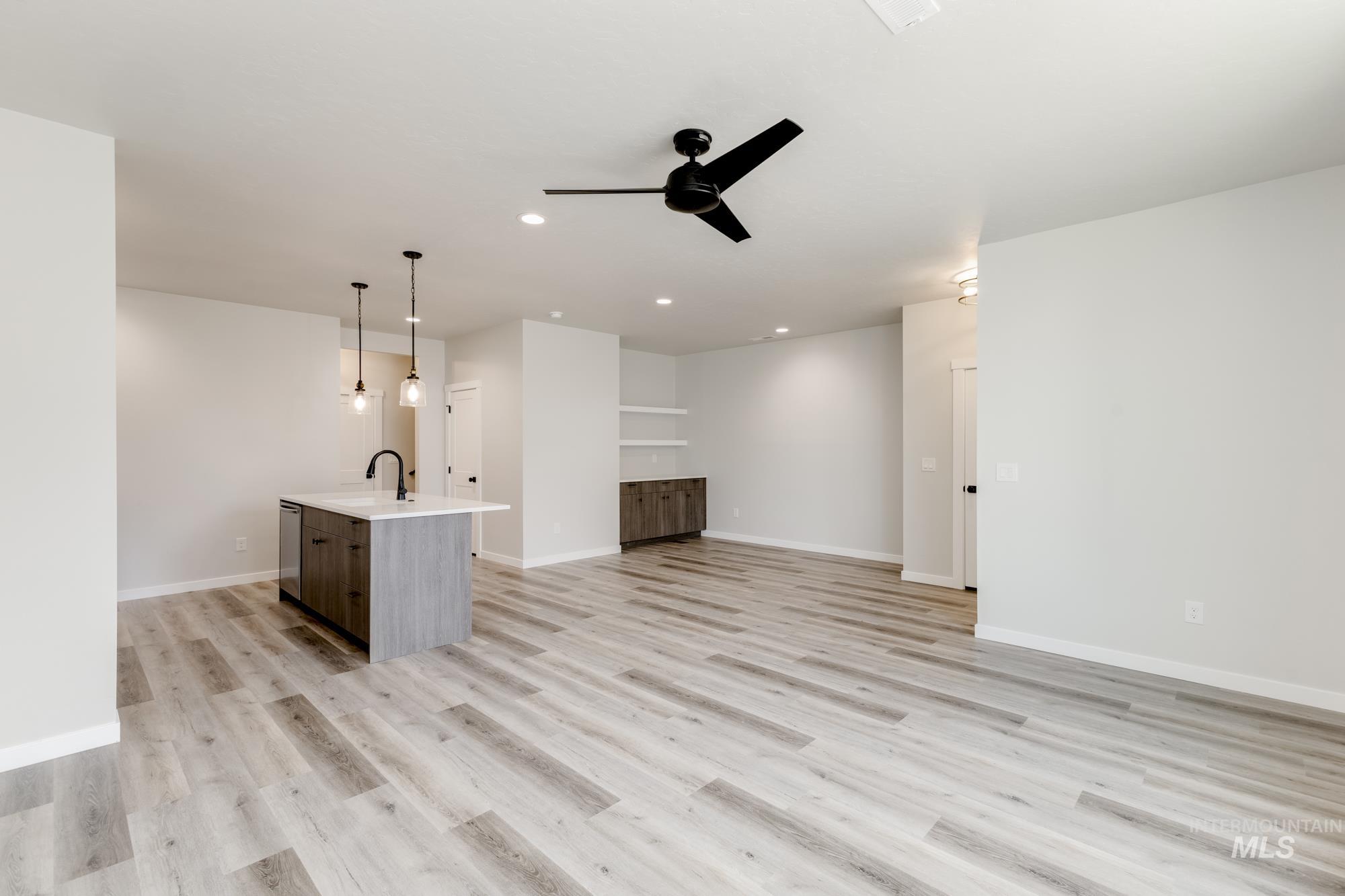 Unfurnished living room featuring light wood-style flooring, recessed lighting, and a ceiling fan