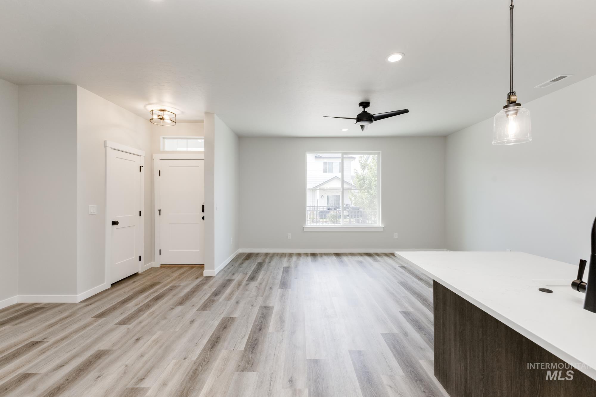 Foyer entrance with light wood-type flooring, a ceiling fan, and recessed lighting