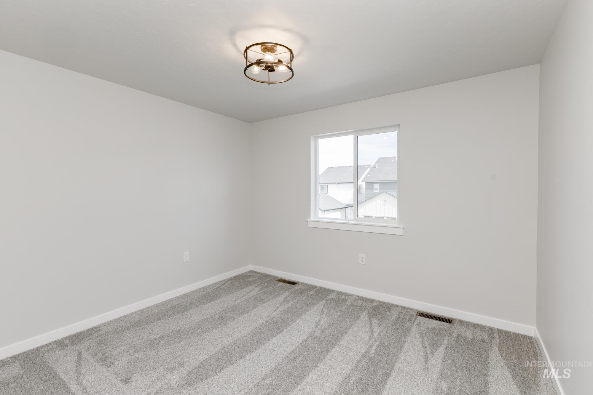 Empty room with carpet floors and baseboards