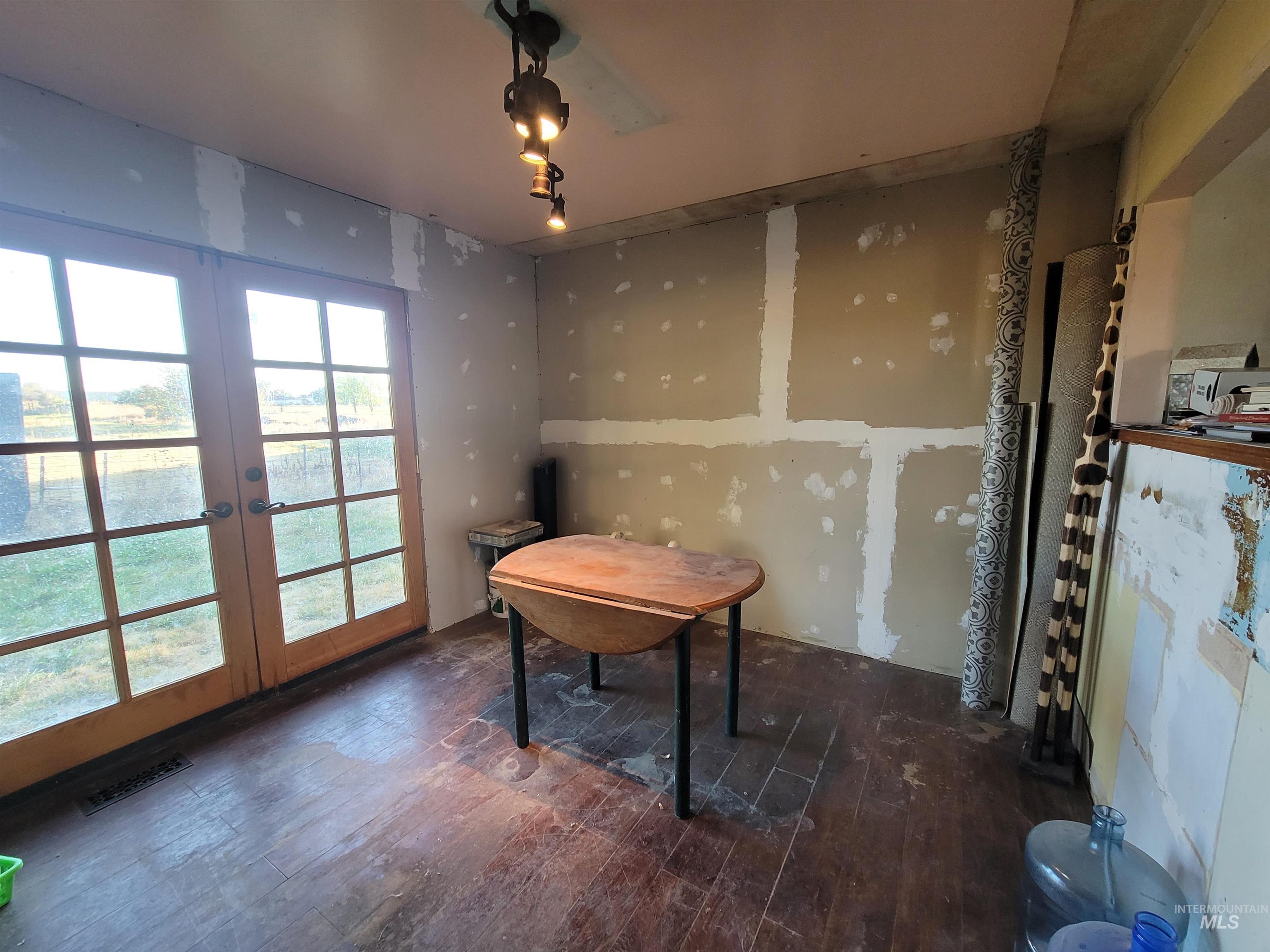 Office space with dark wood-style floors and french doors