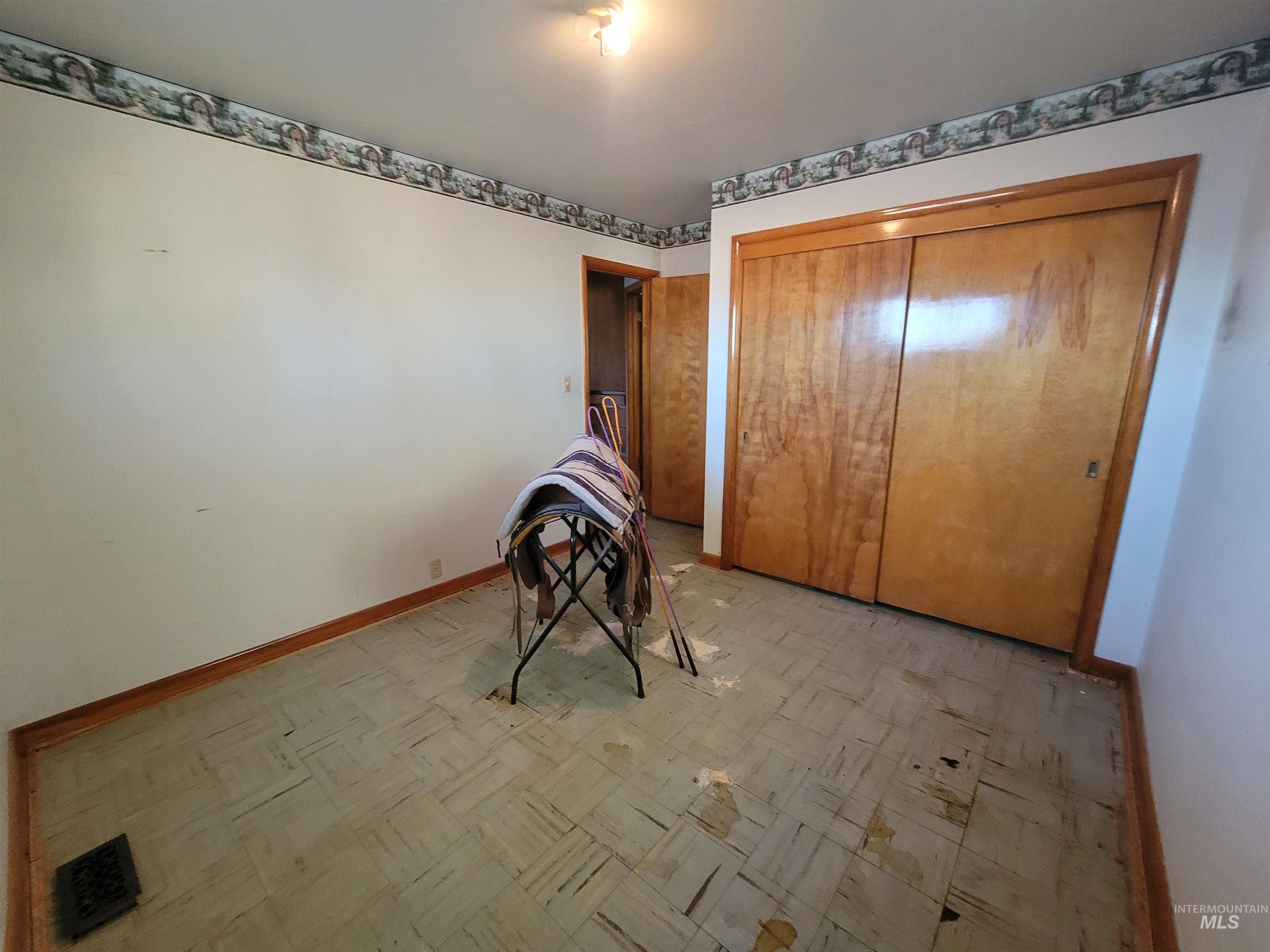 Bedroom featuring light floors and a closet