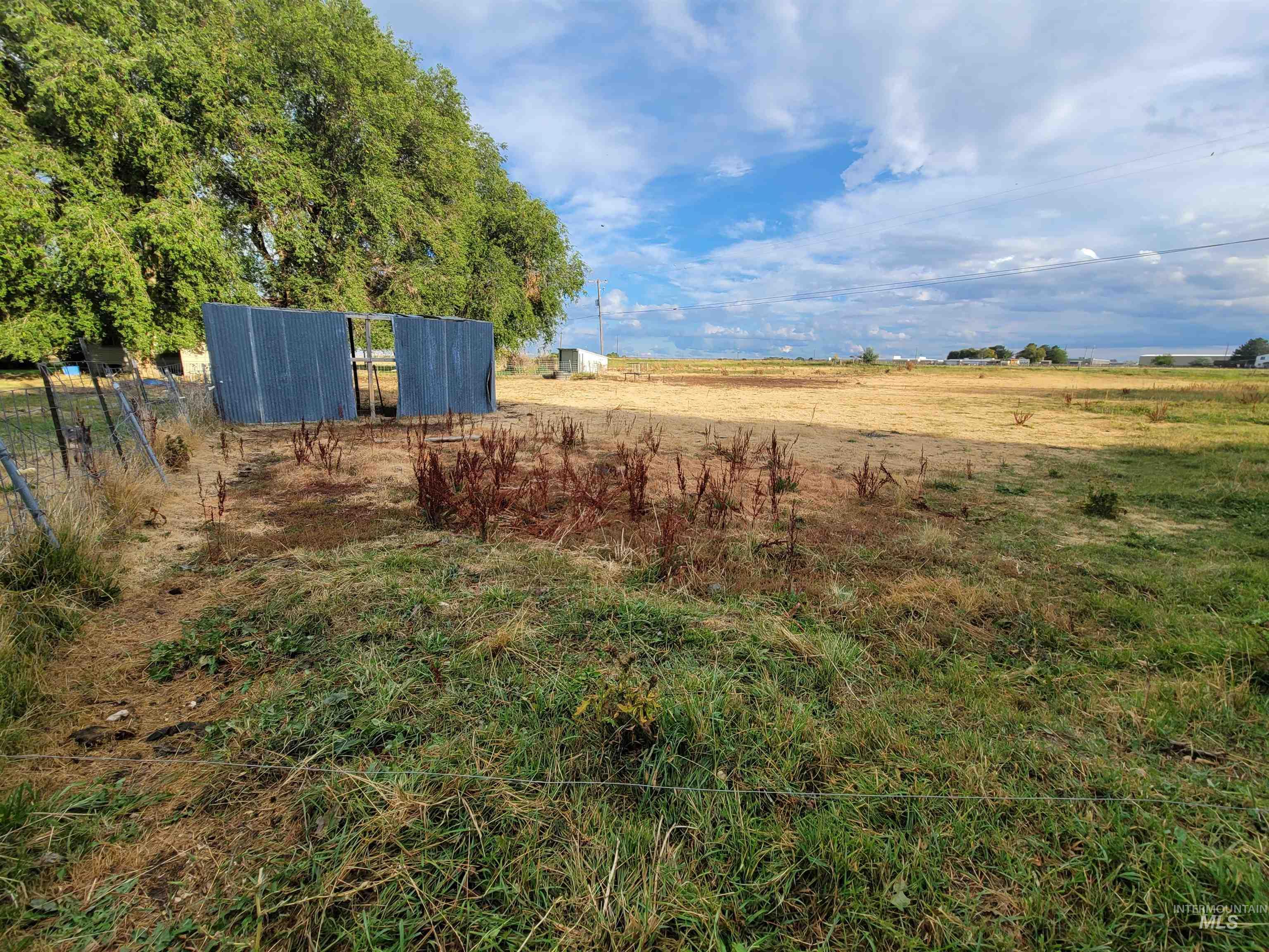 View of yard featuring a view of countryside, an outdoor structure, and a pole building
