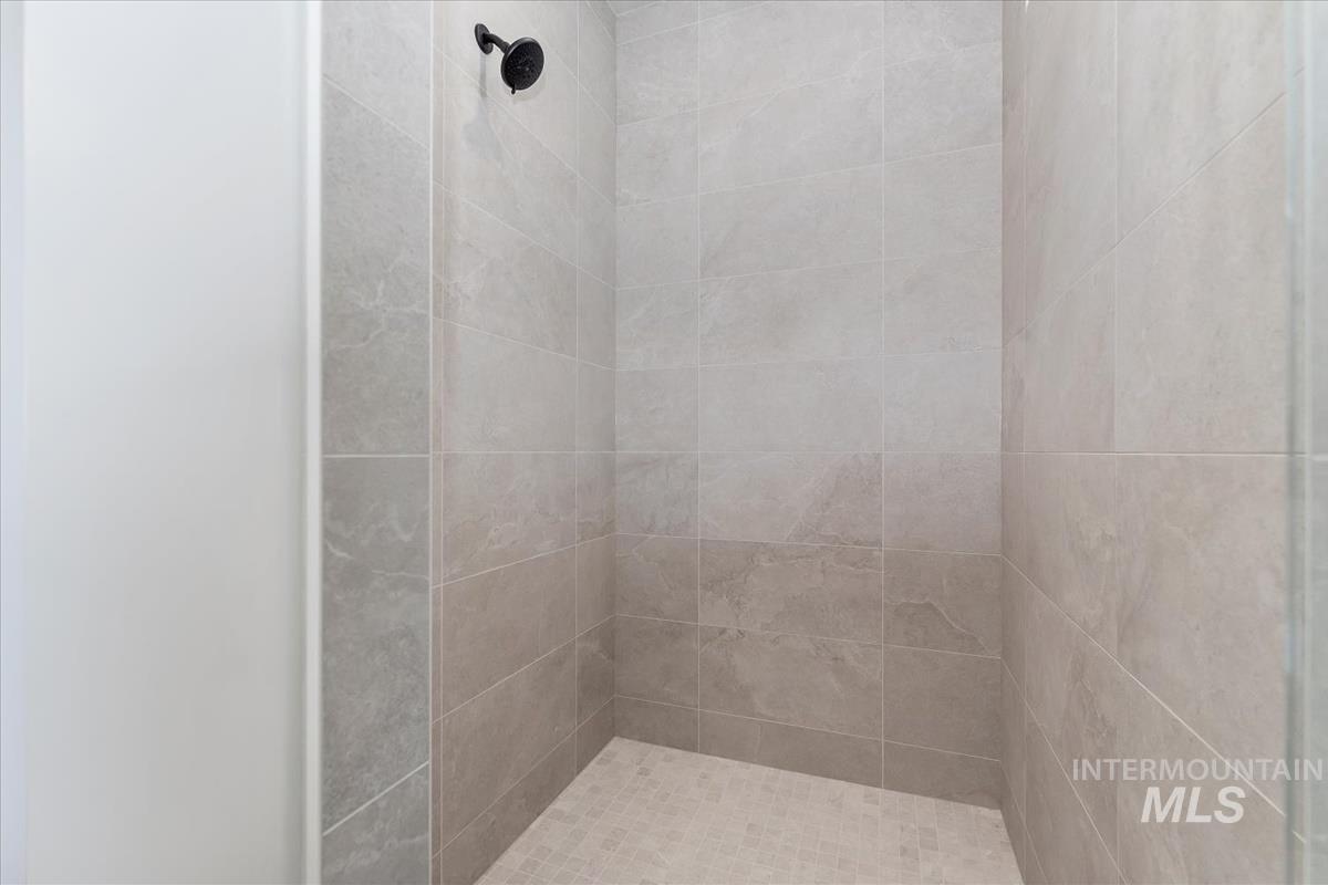 Full bath featuring a tile shower