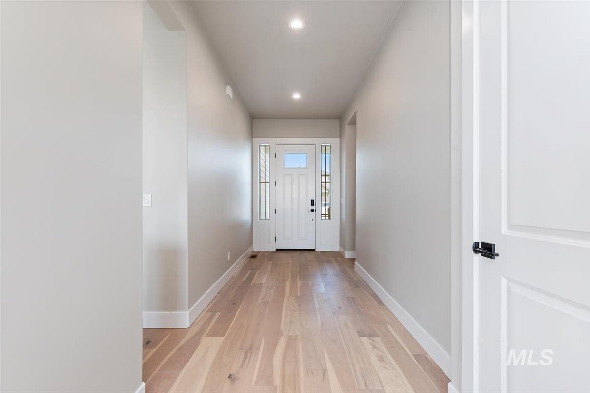 Doorway to outside featuring wood finished floors and recessed lighting