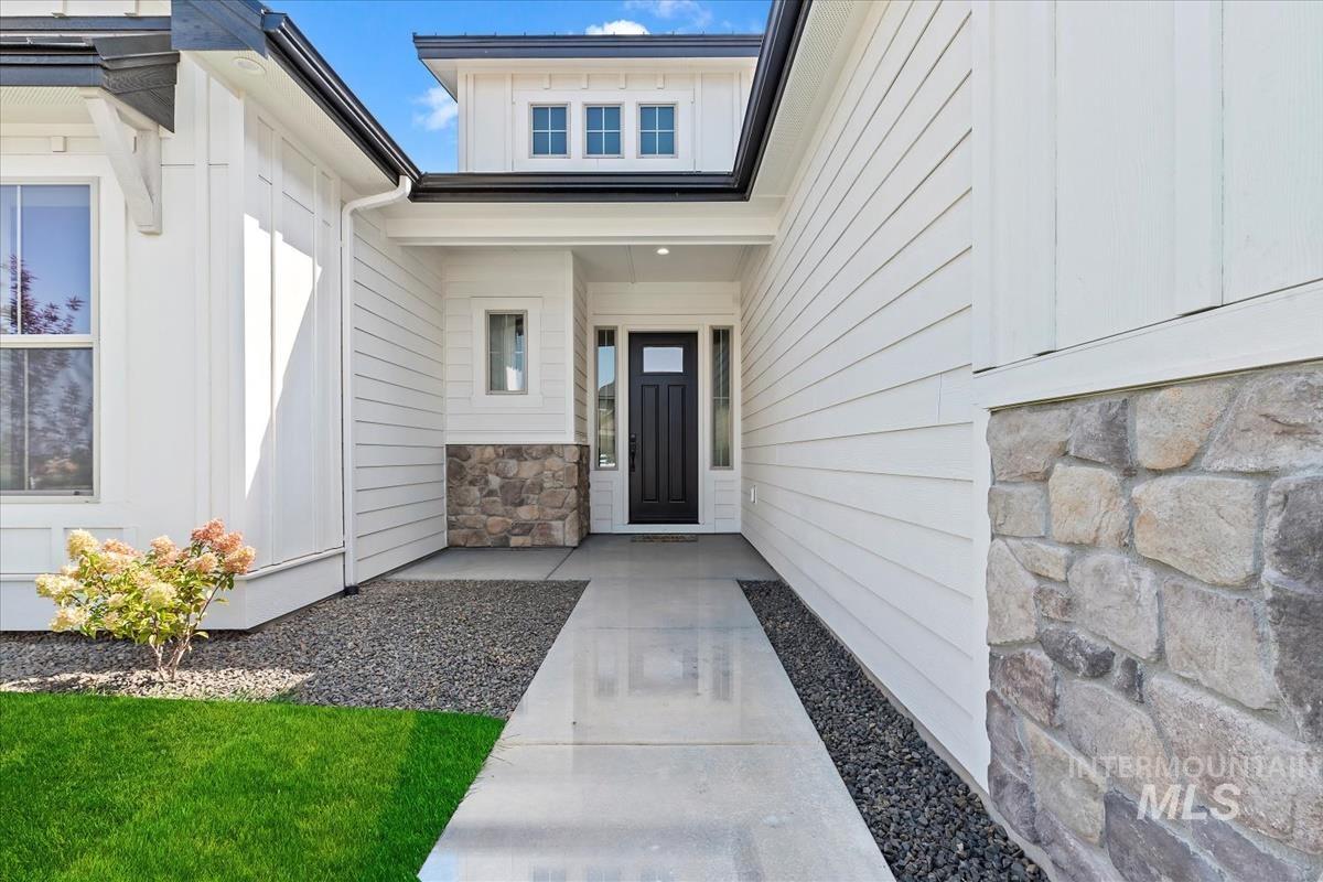 Doorway to property with stone siding