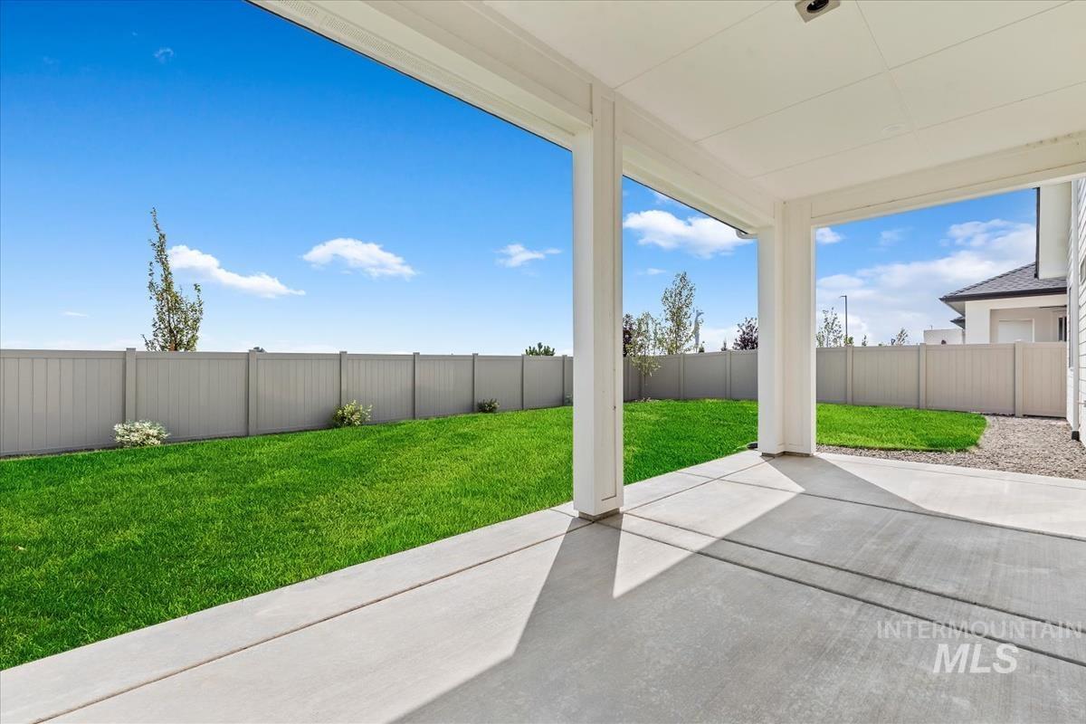 Fenced backyard with a patio