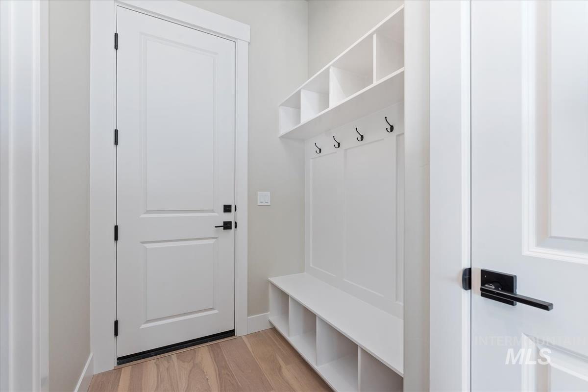 Mudroom featuring light wood-style floors and baseboards