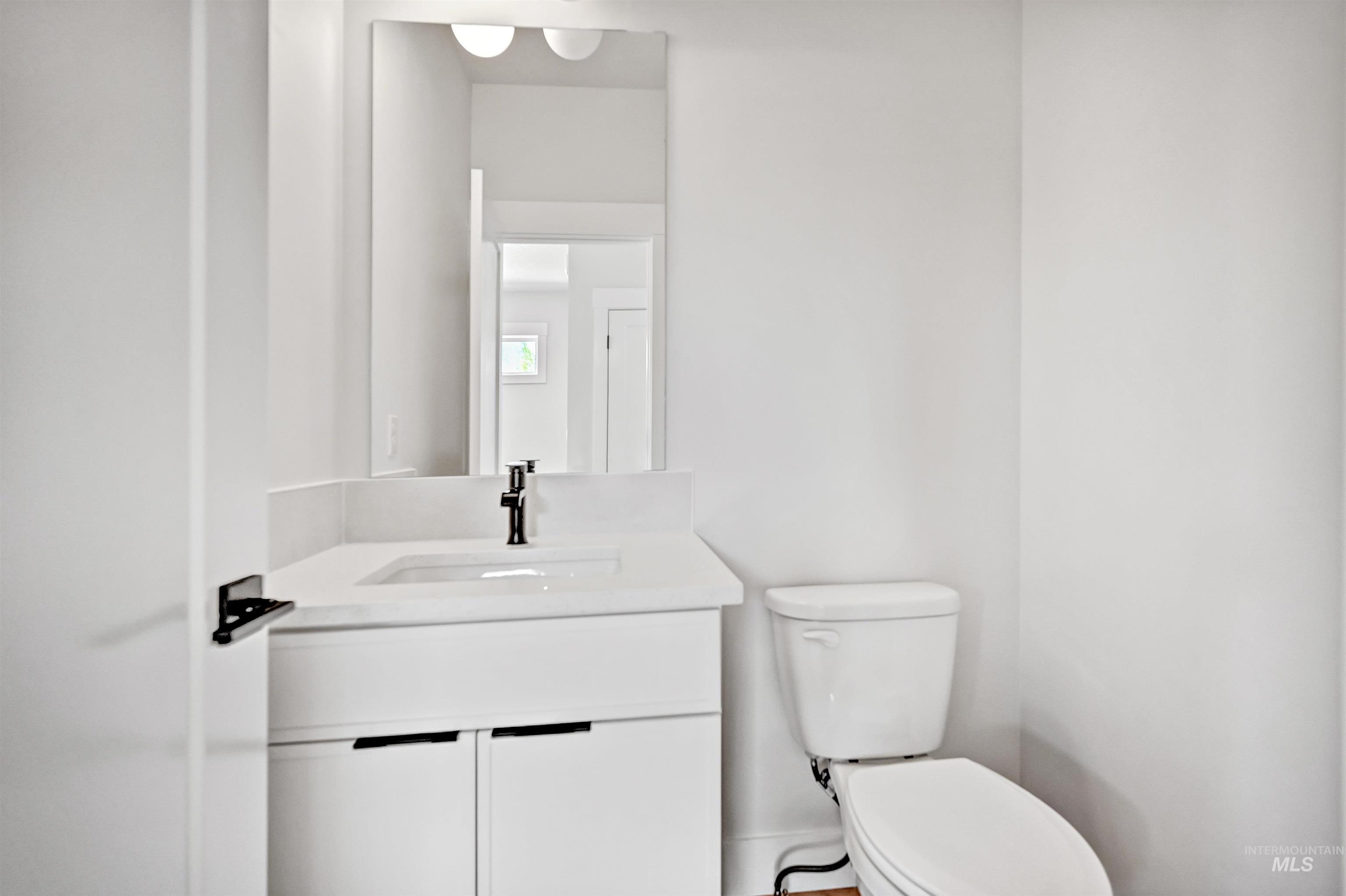 Half bath with vanity and toilet