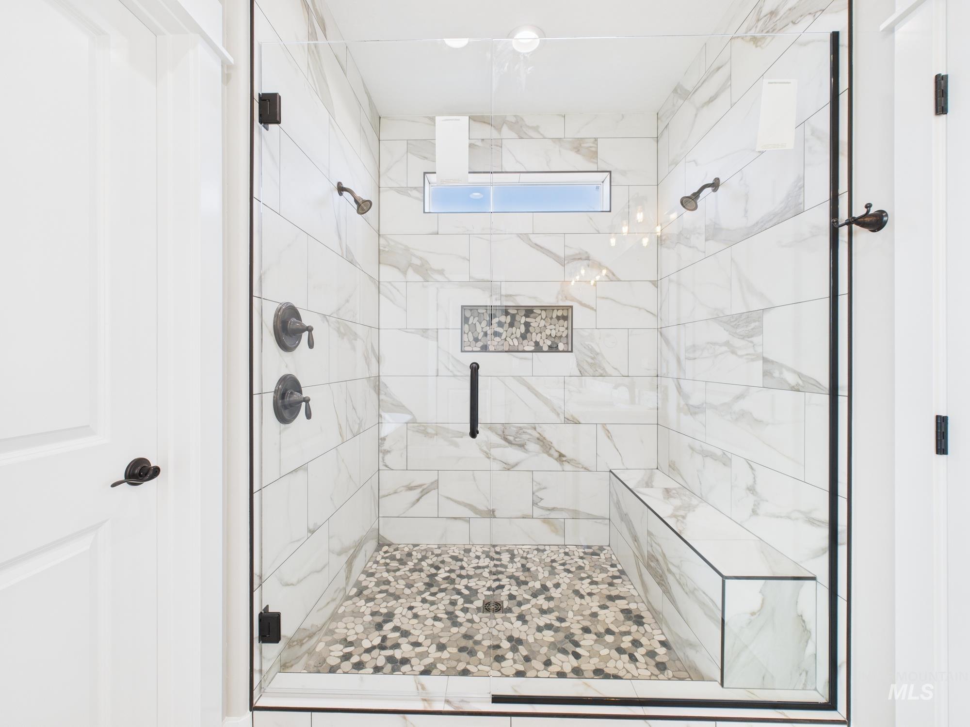 Bathroom featuring a marble finish shower