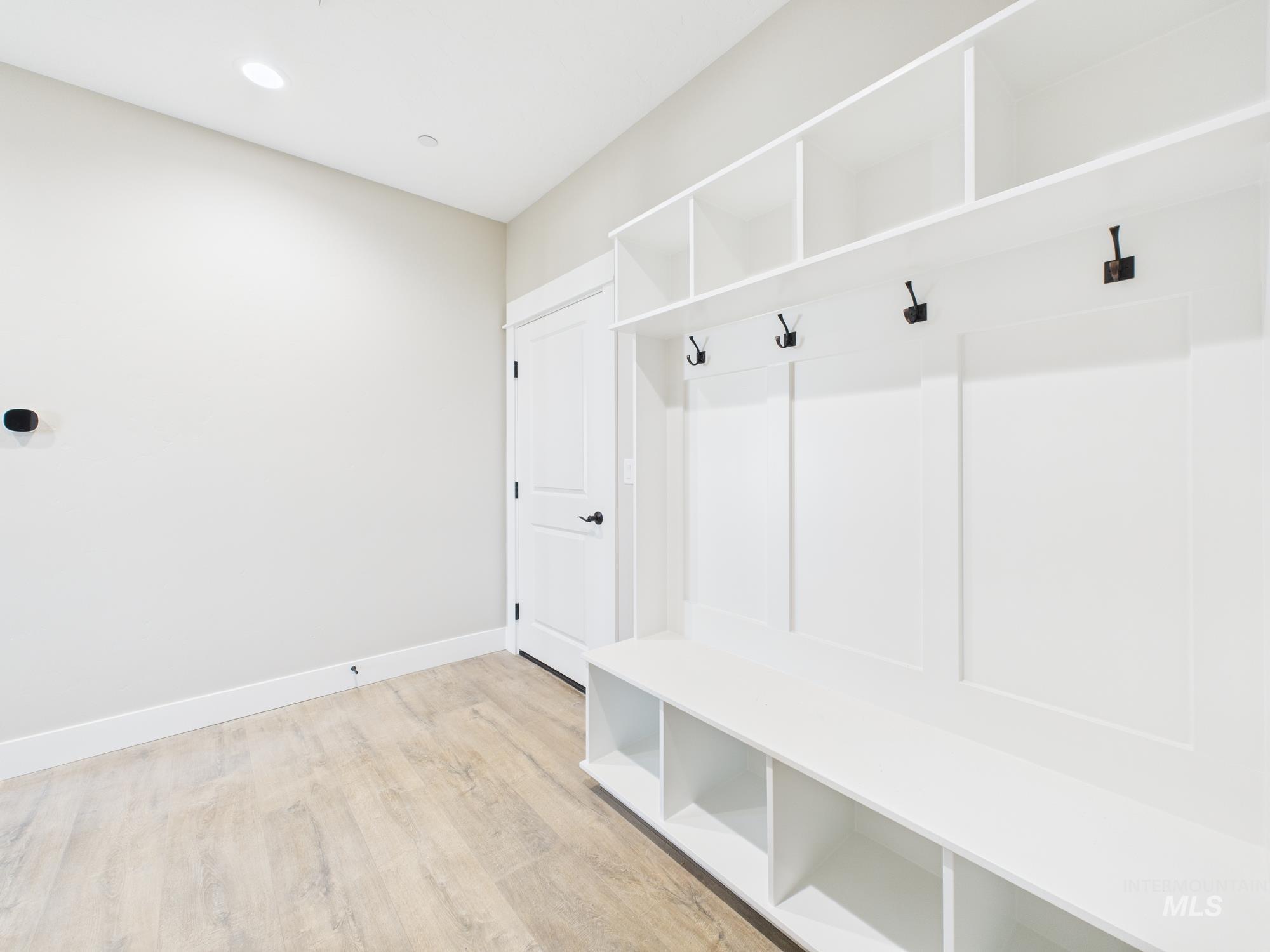 Mudroom featuring light wood-style flooring and recessed lighting