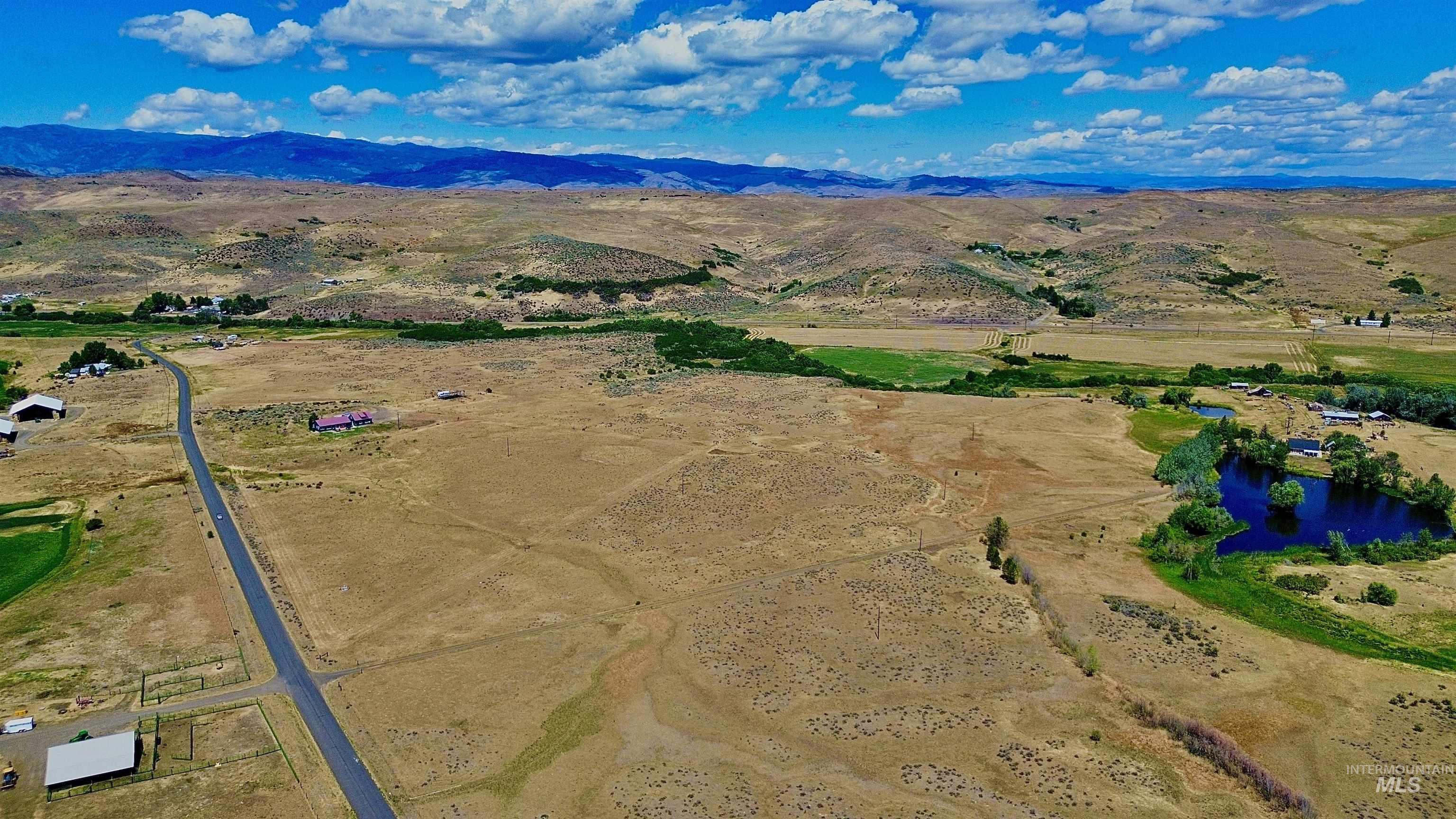 Aerial view of sparsely populated area featuring a water and mountain view