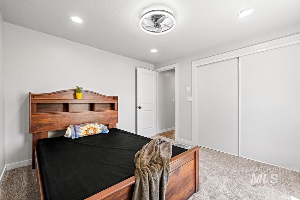 Carpeted bedroom featuring a closet and recessed lighting