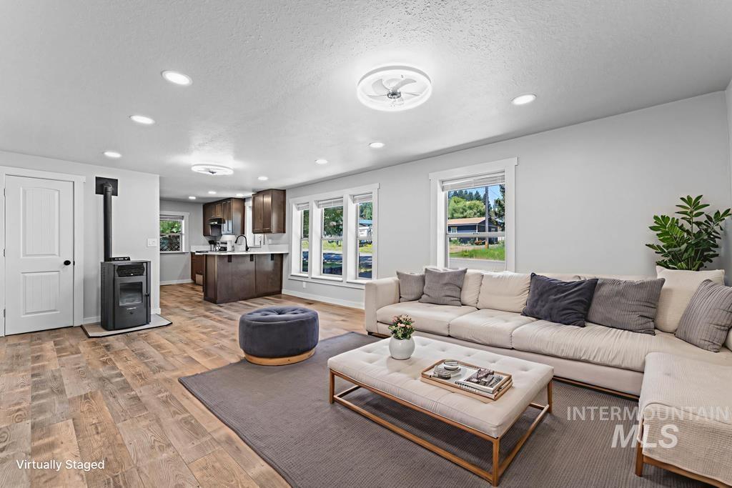 Living area with light wood-style floors, recessed lighting, and a textured ceiling