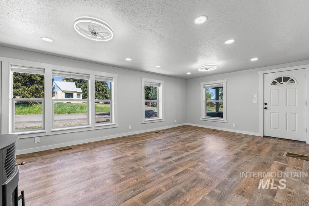 Foyer featuring a textured ceiling, wood finished floors, and recessed lighting