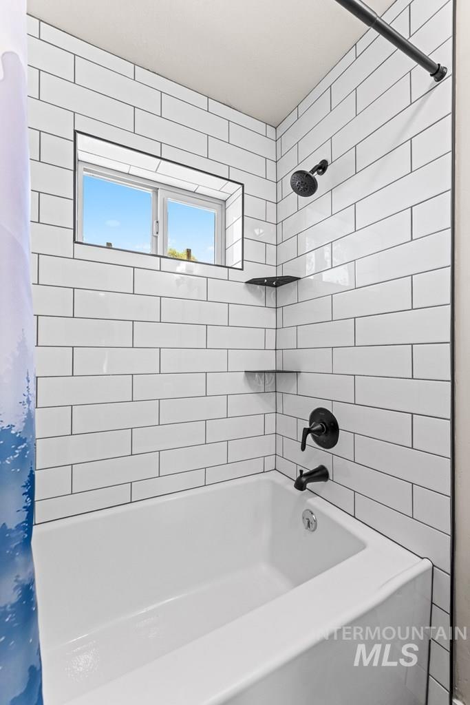 Bathroom featuring shower / bath combination with curtain