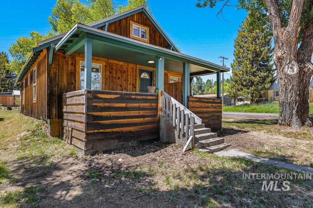 View of front of home with covered porch and board and batten siding