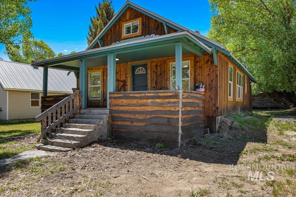 View of front of property featuring covered porch and board and batten siding