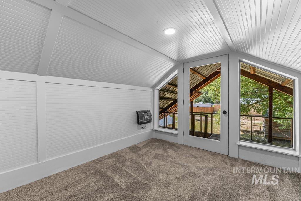 Bonus room featuring carpet, lofted ceiling, and heating unit