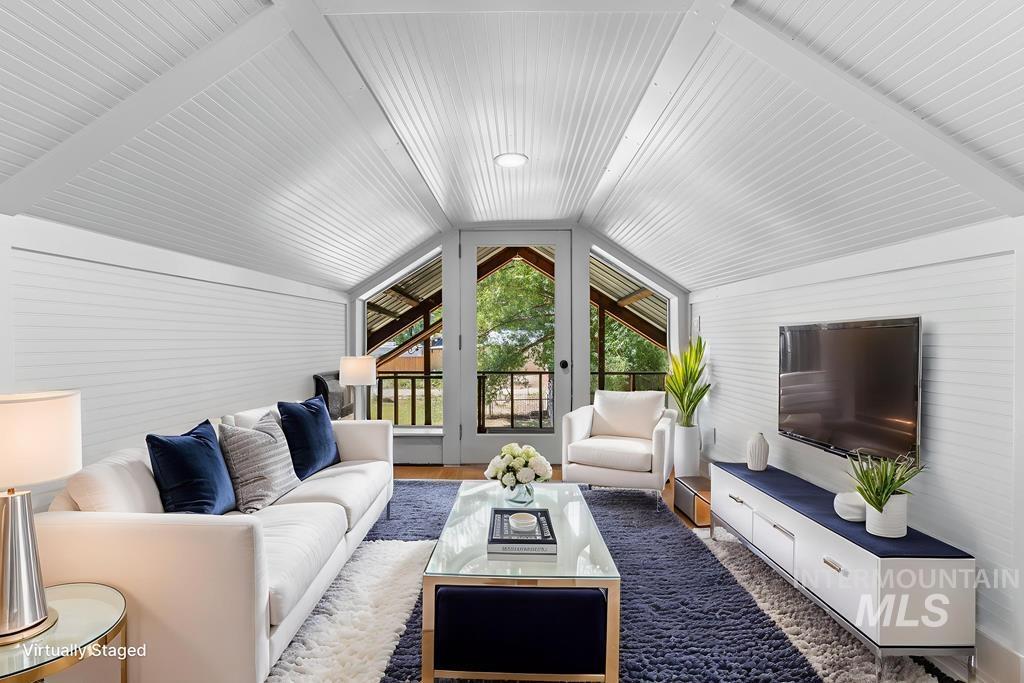 Living room featuring wood finished floors and lofted ceiling