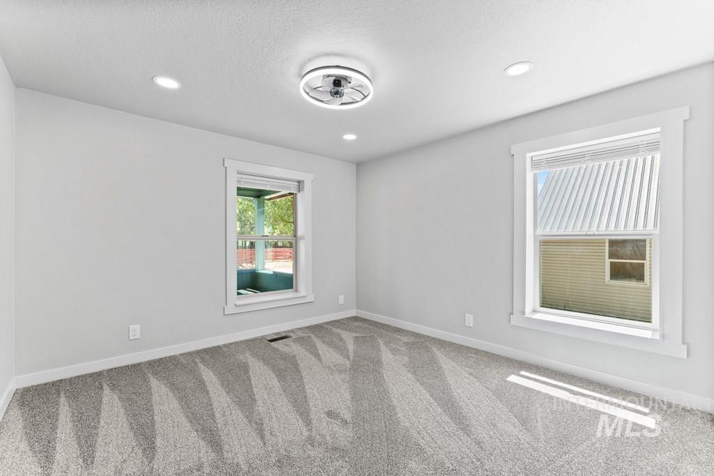 Unfurnished room with carpet, recessed lighting, and a textured ceiling