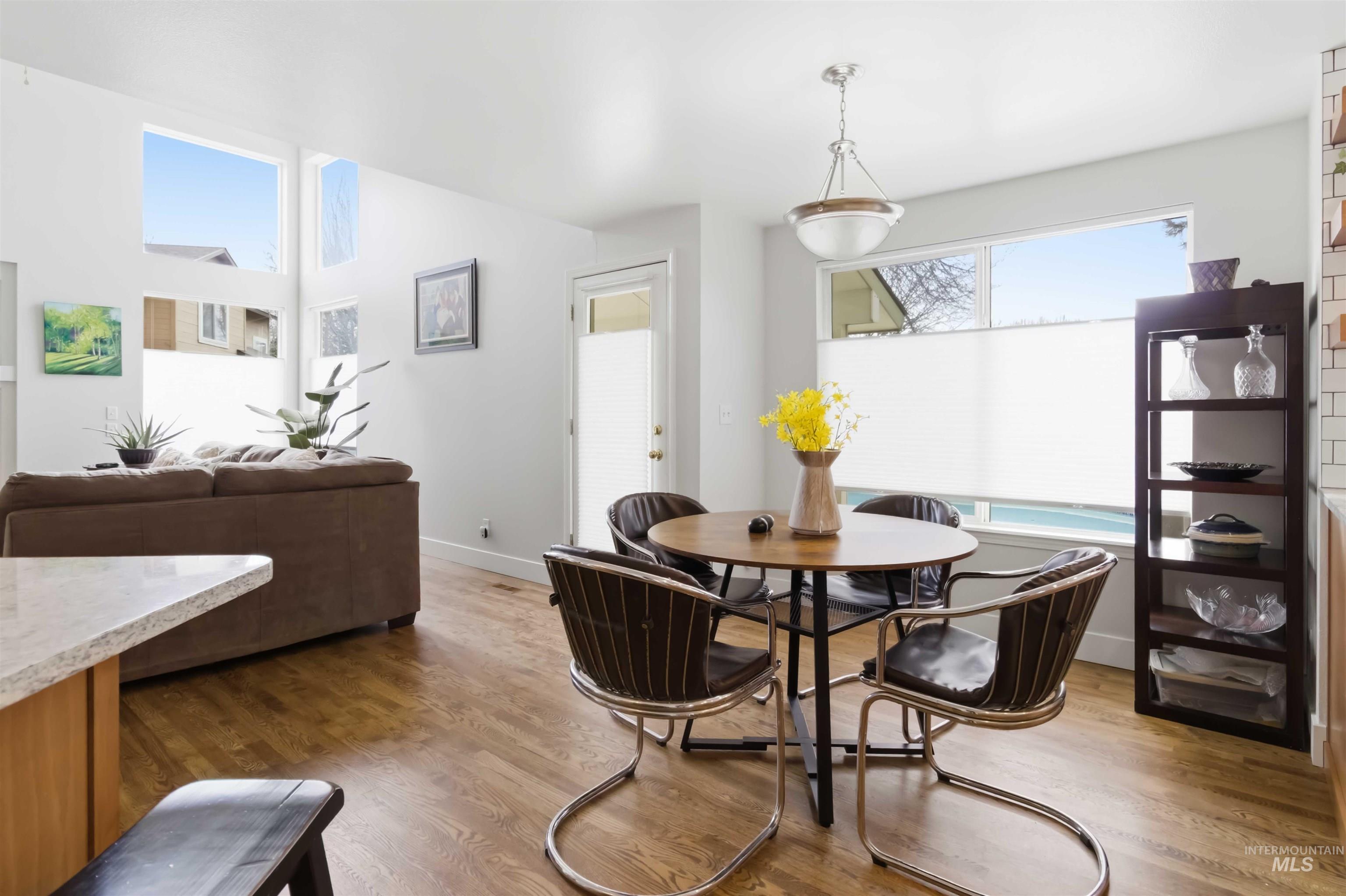 Dining space with wood finished floors and baseboards