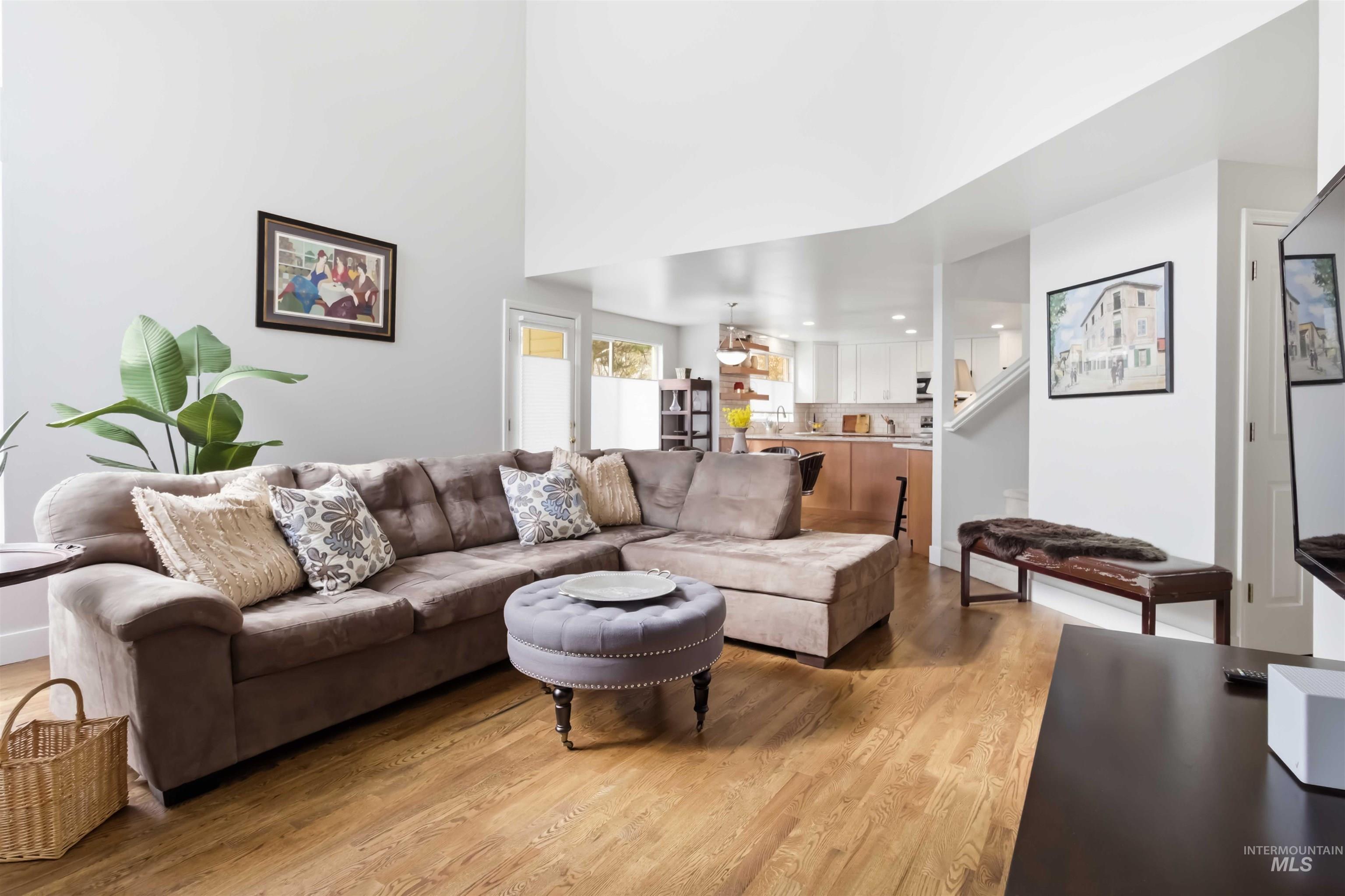 Living room featuring light wood finished floors and recessed lighting