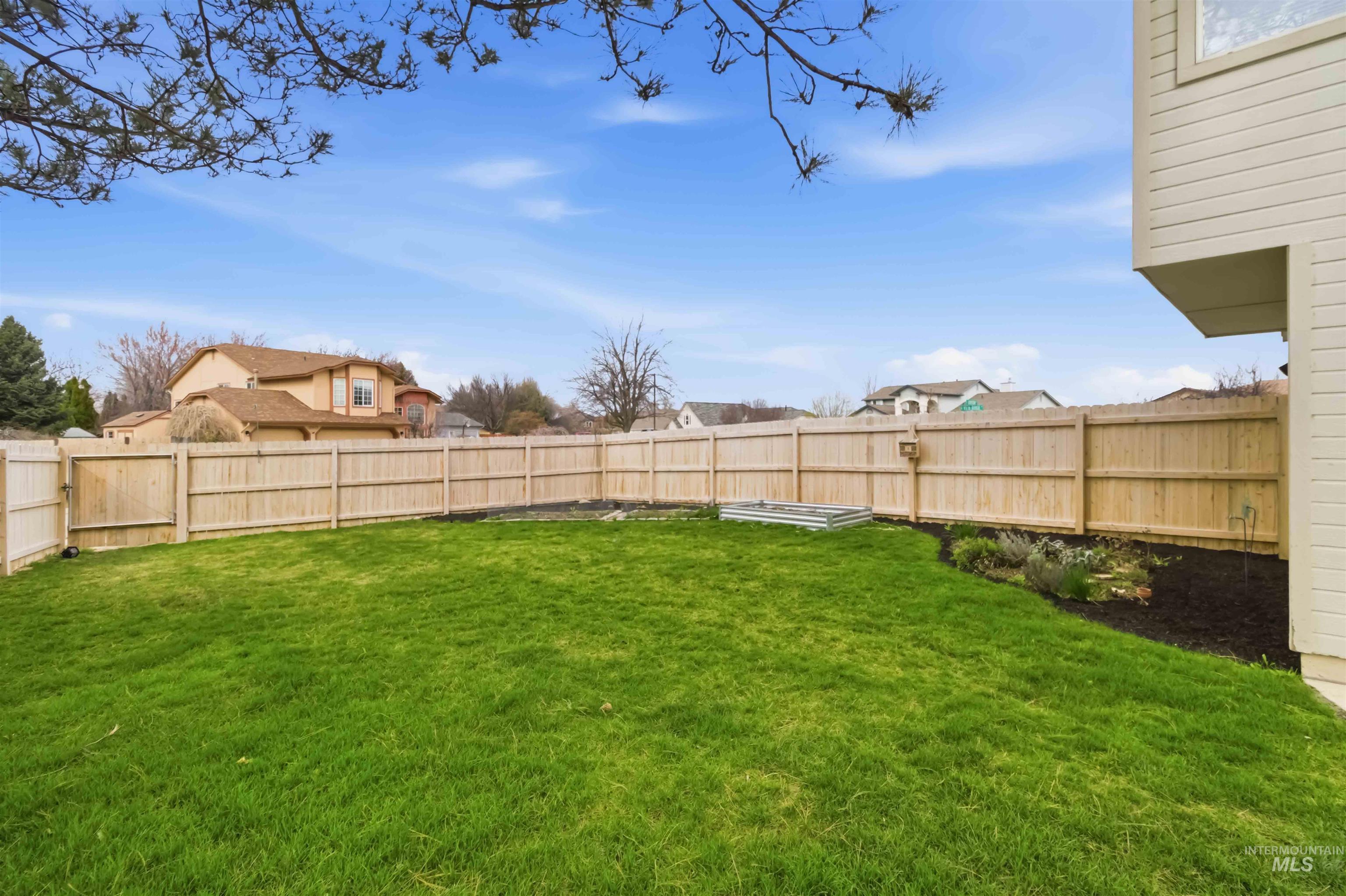 View of fenced backyard