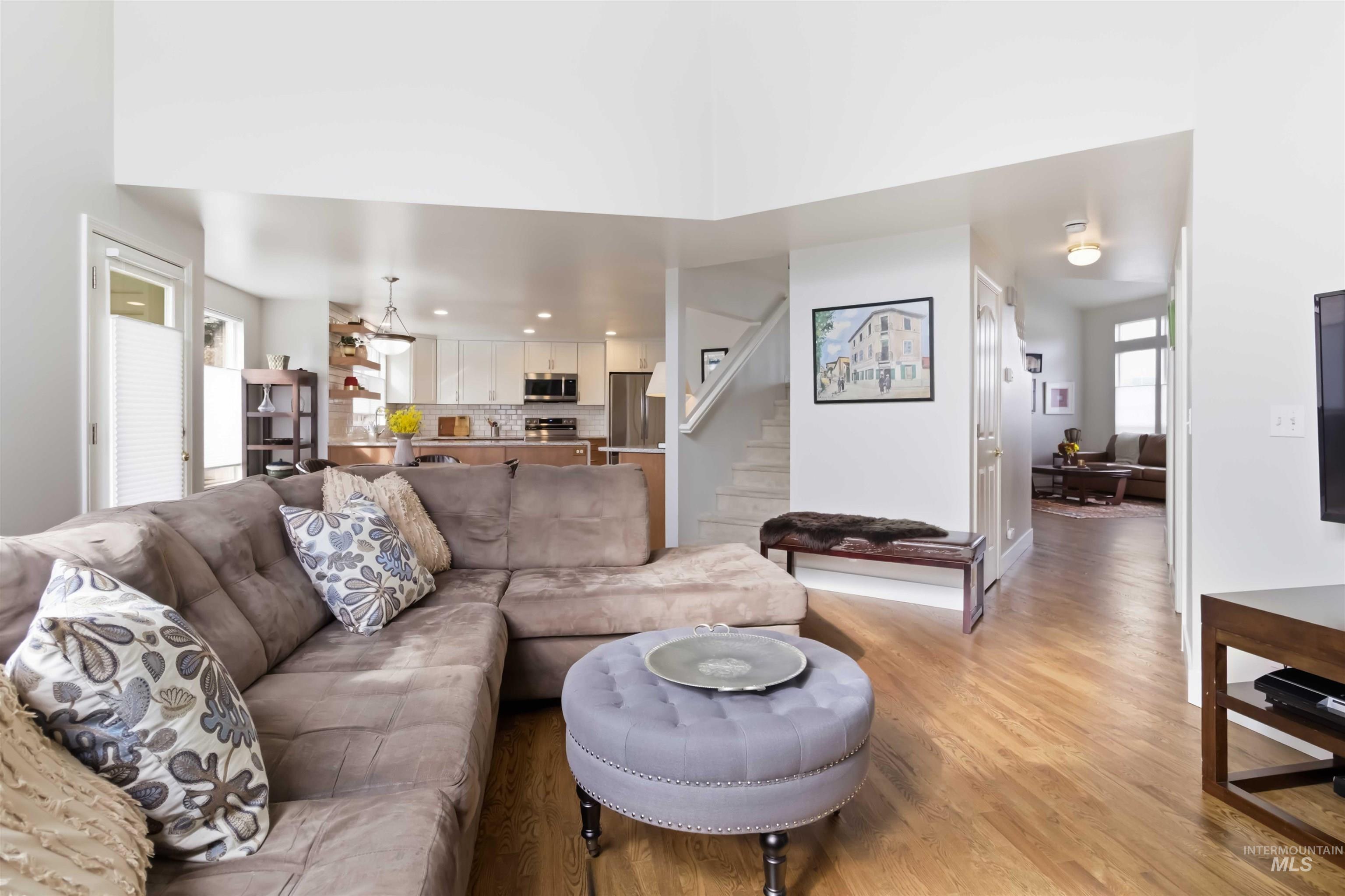 Living room featuring light wood finished floors and stairway