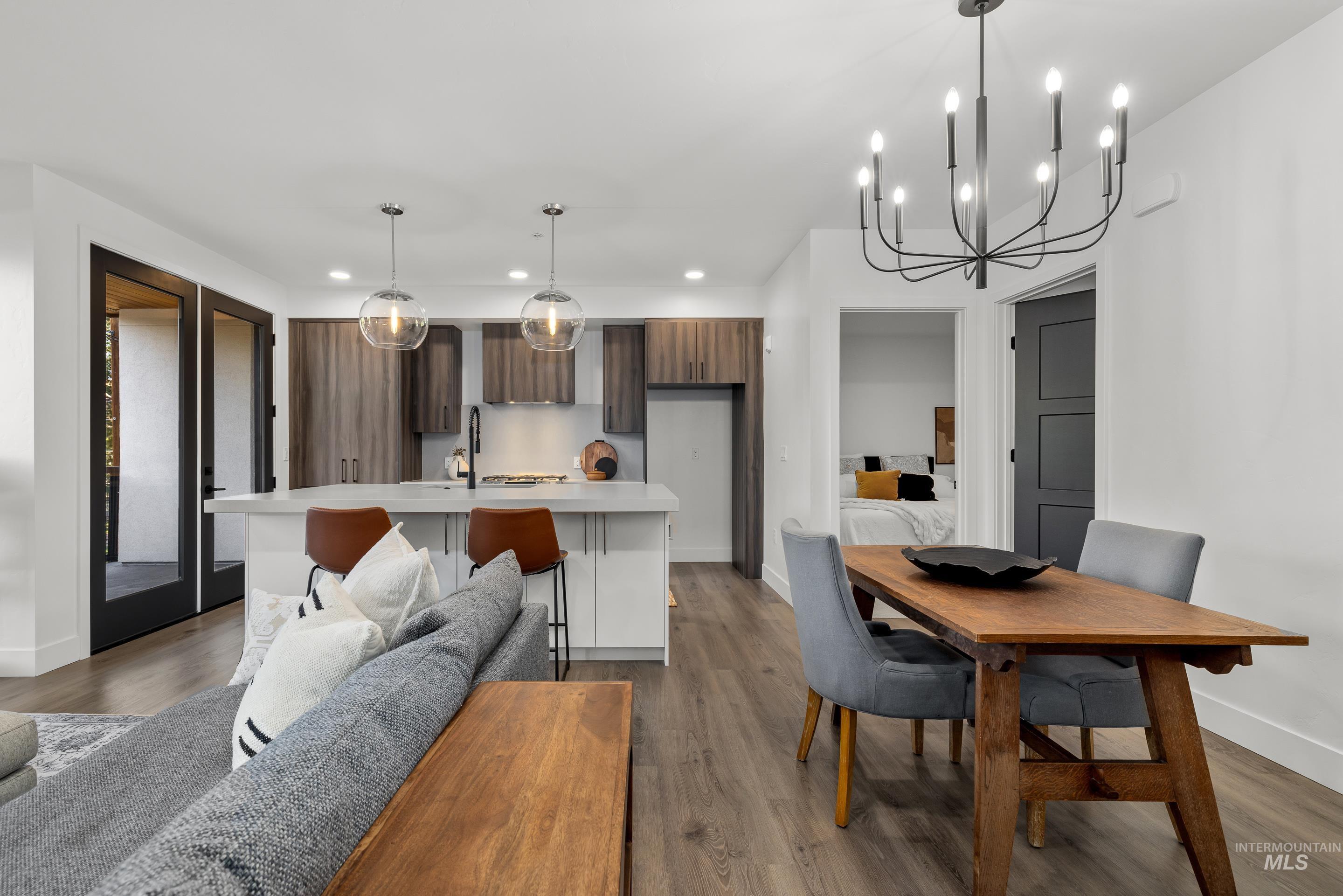 Dining room featuring dark wood-style floors, a chandelier, and recessed lighting