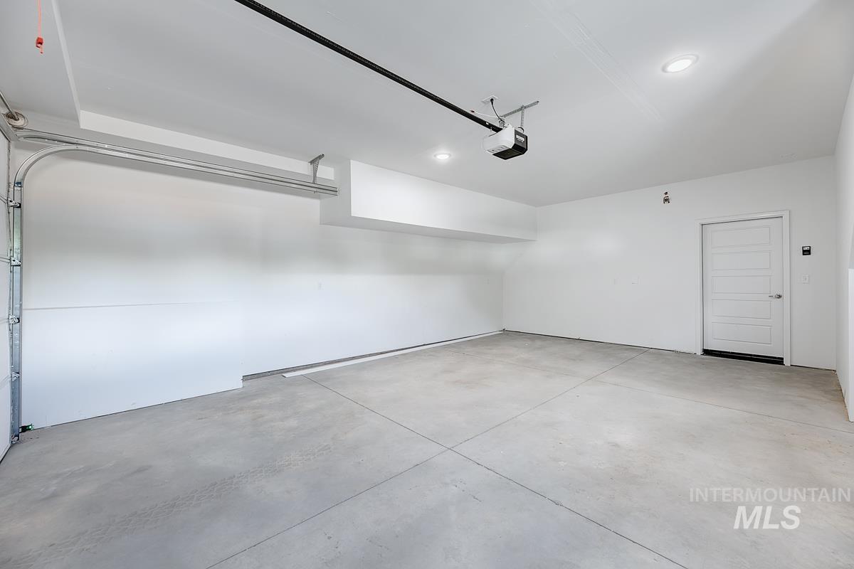 Garage with recessed lighting and a garage door opener