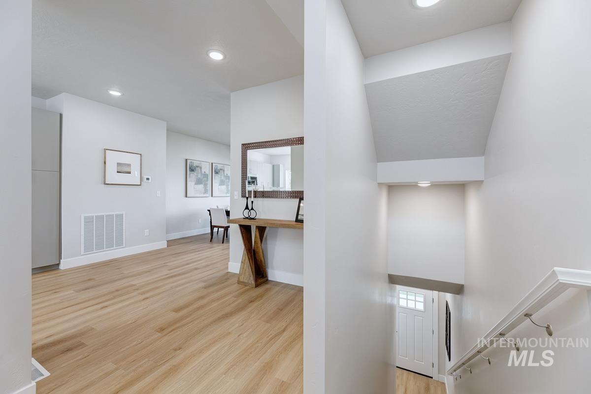 Hallway featuring light wood-type flooring and recessed lighting