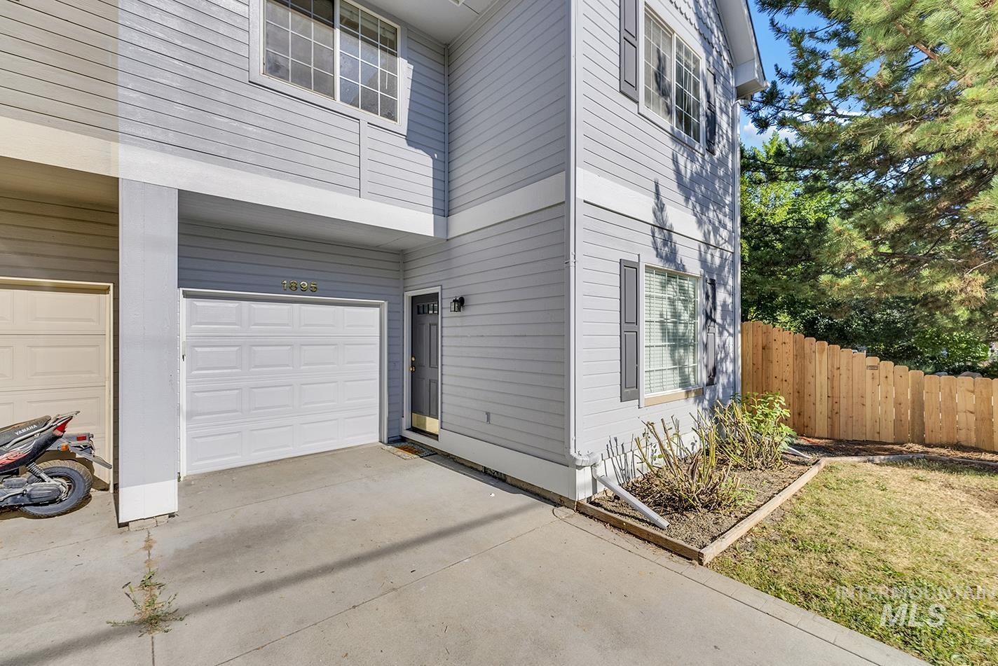 View of side of property featuring a garage and driveway