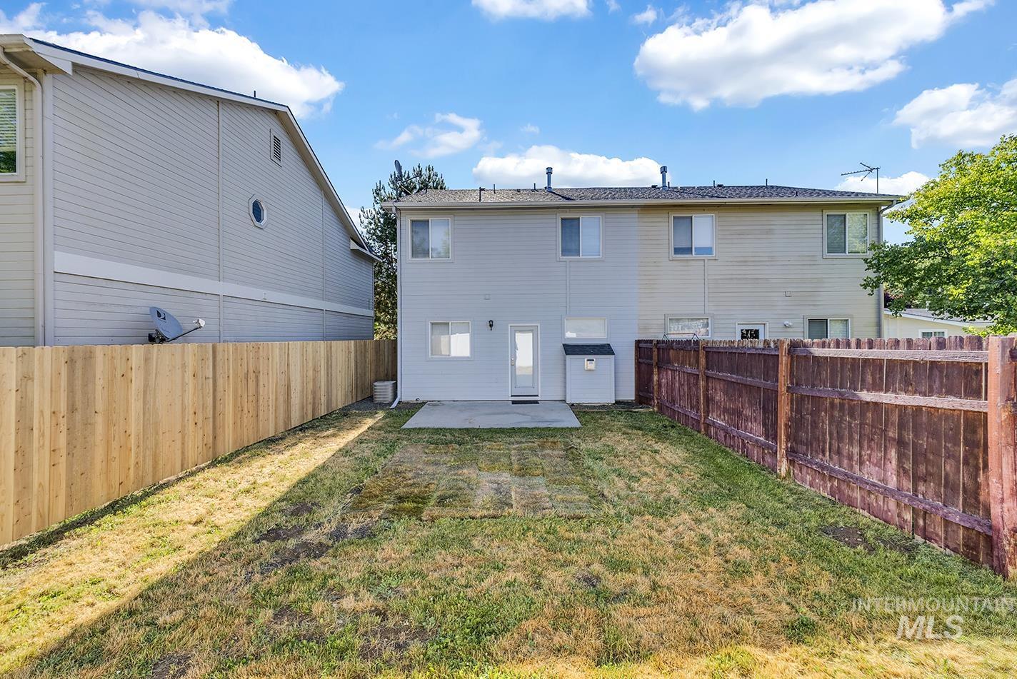 Rear view of property featuring a patio area and a fenced backyard