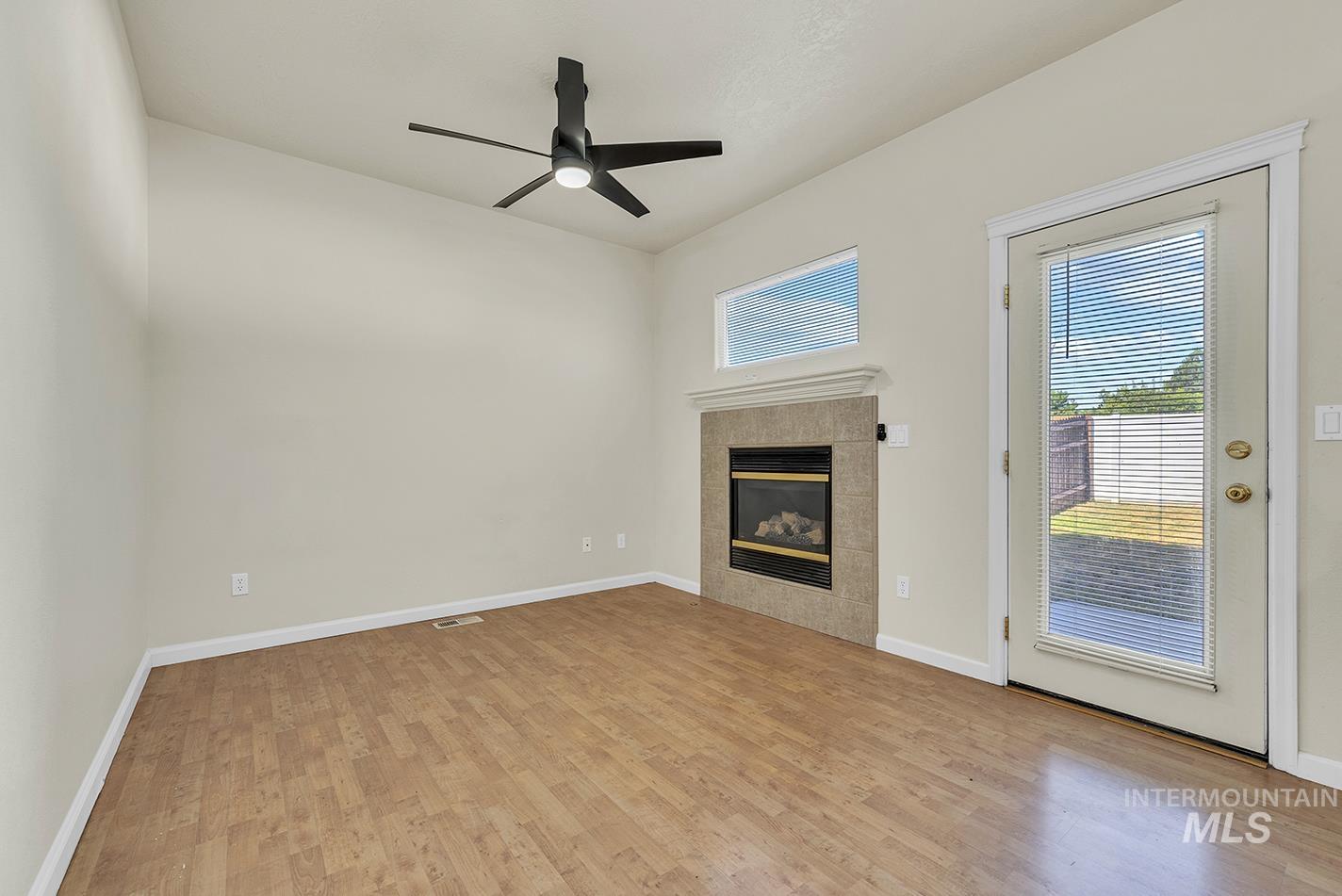 Unfurnished living room with plenty of natural light and wood finished floors