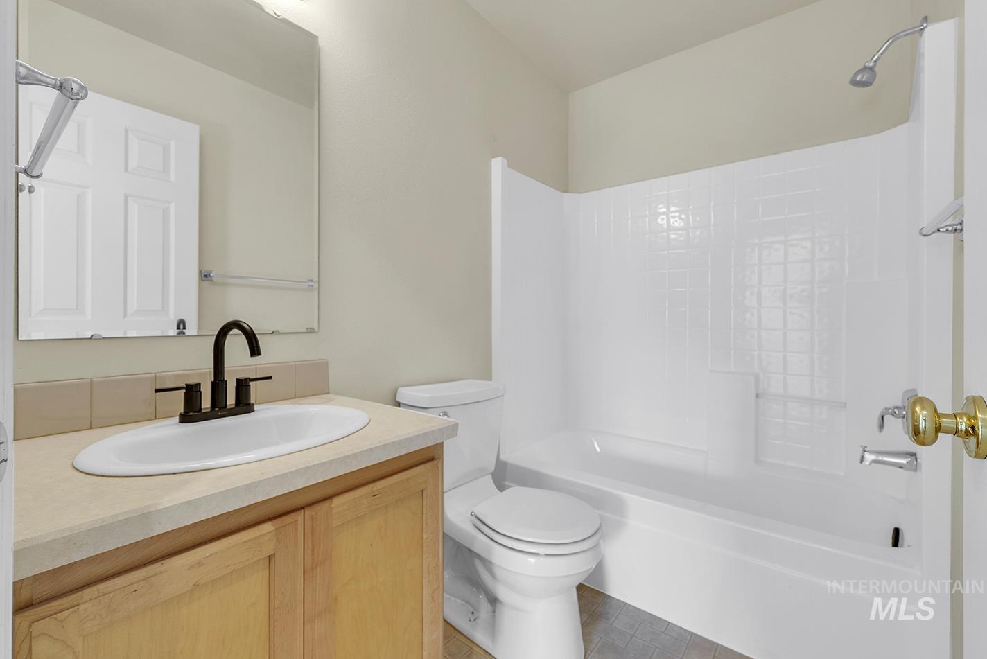 Bathroom featuring vanity and shower / bathtub combination