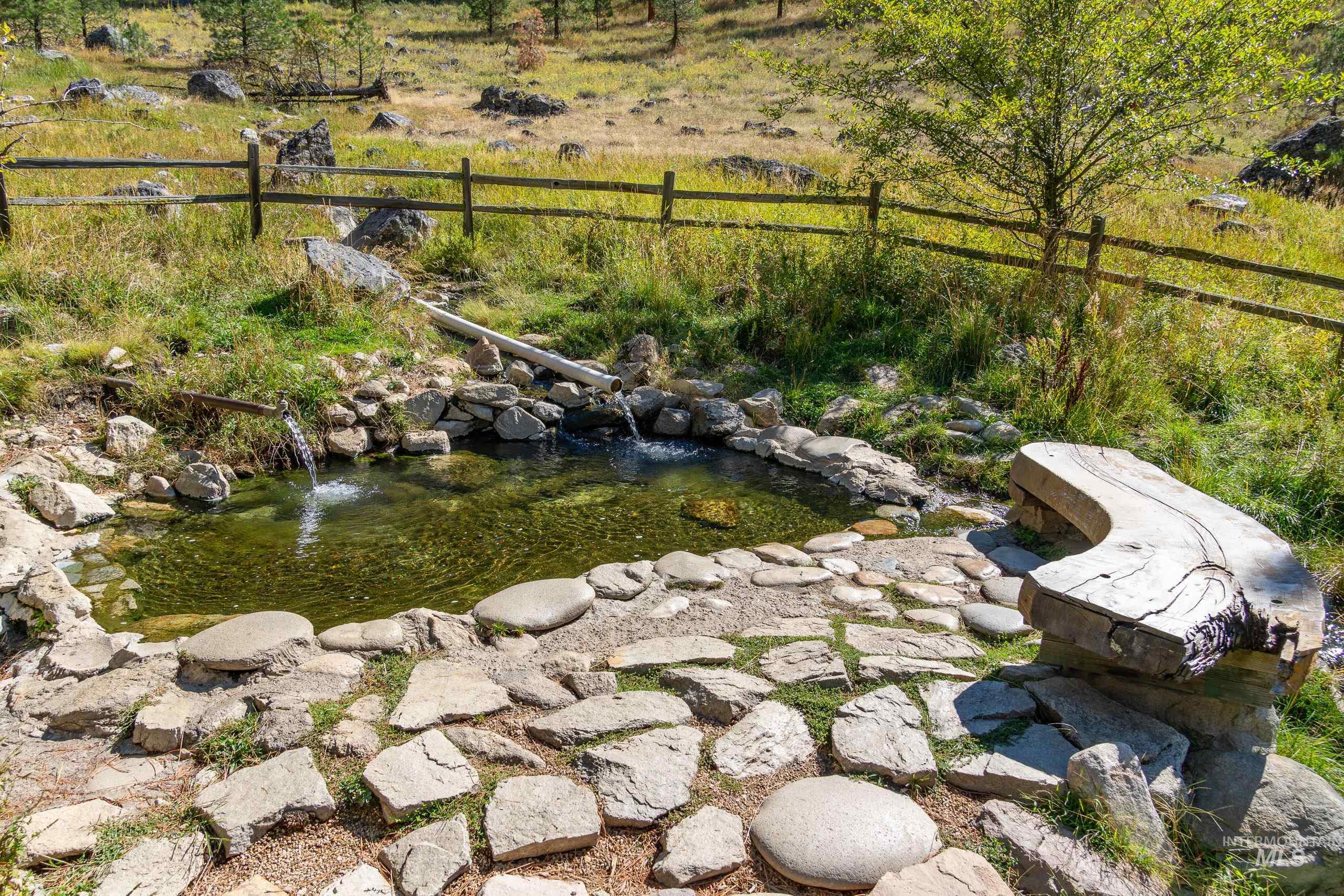 View of yard with a garden pond