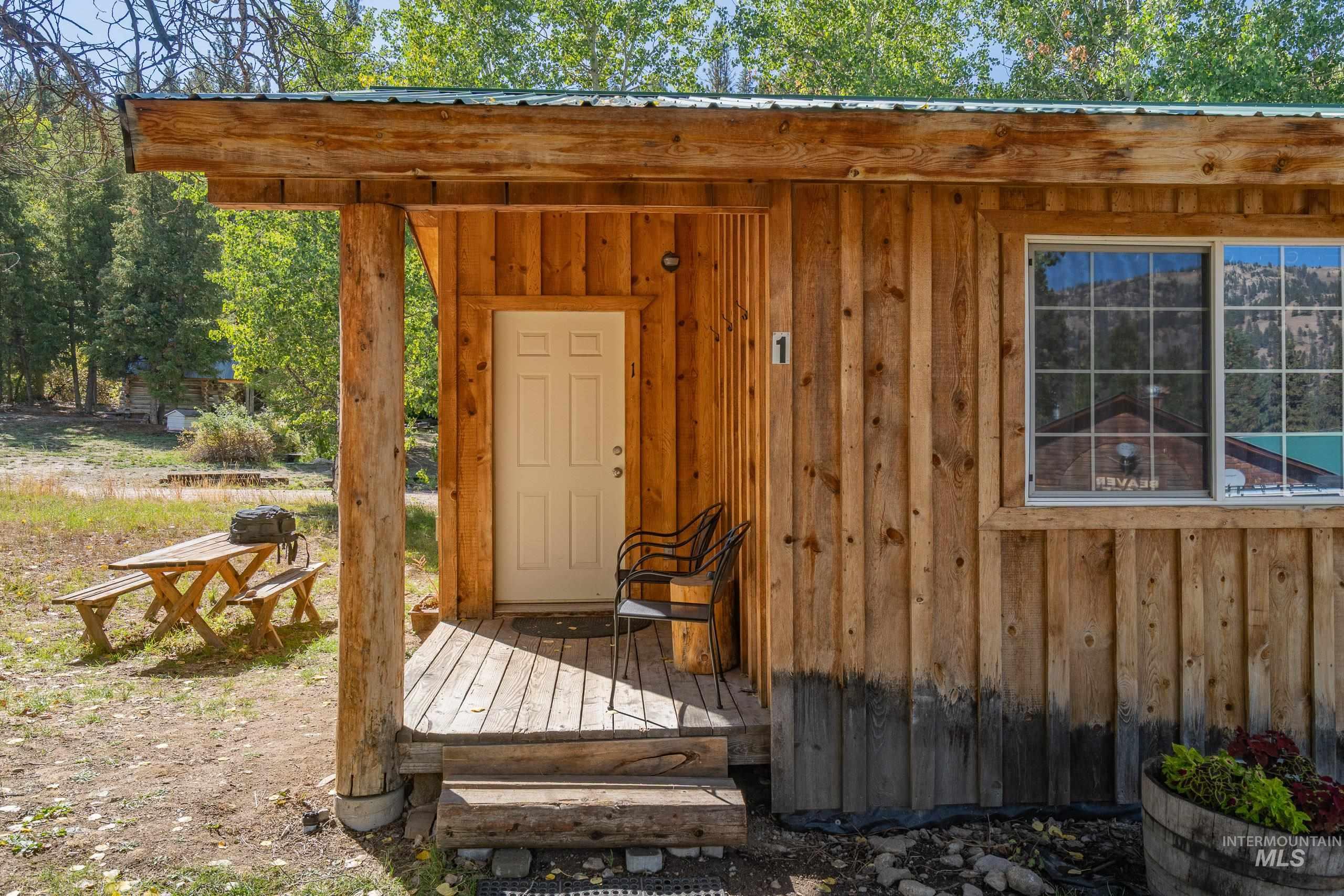 Property entrance featuring board and batten siding and a wooden deck