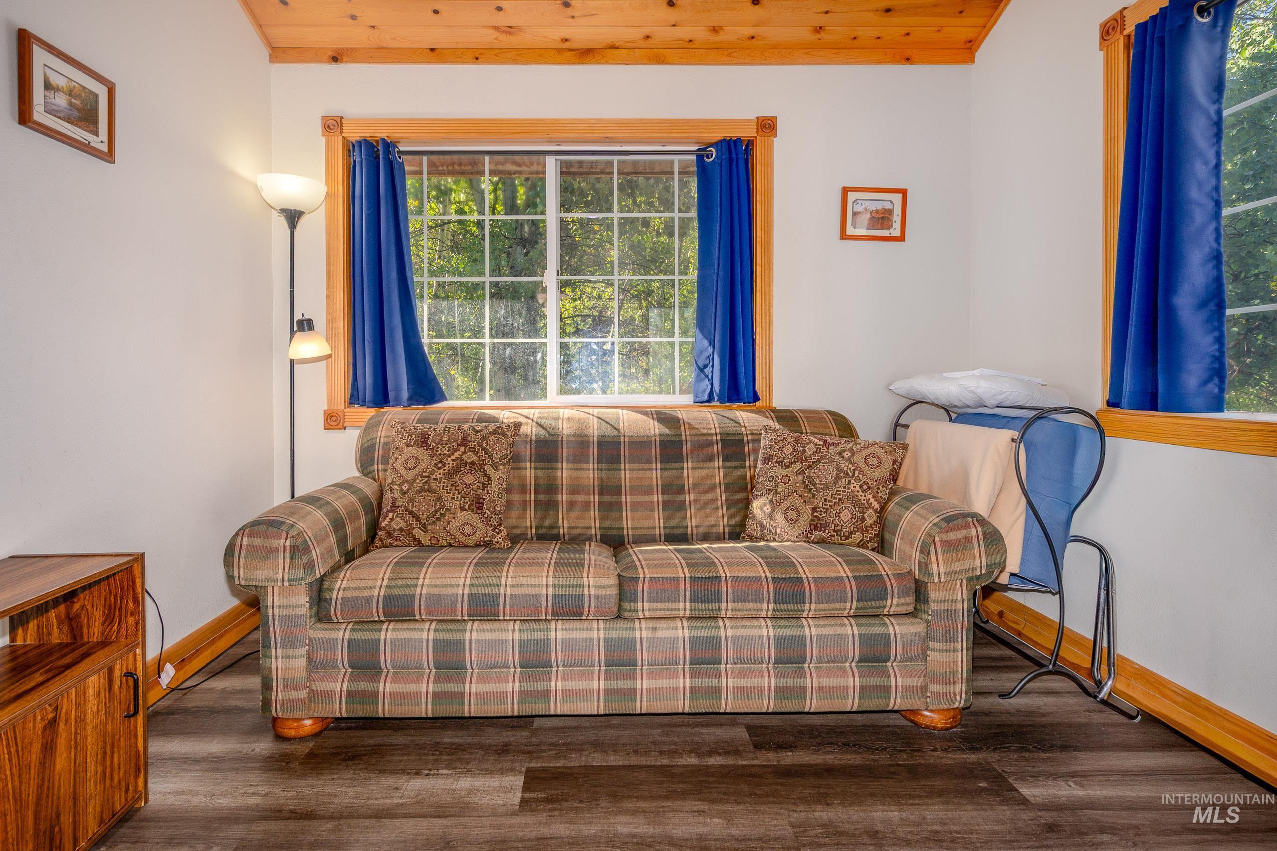Living area with wood finished floors and wooden ceiling