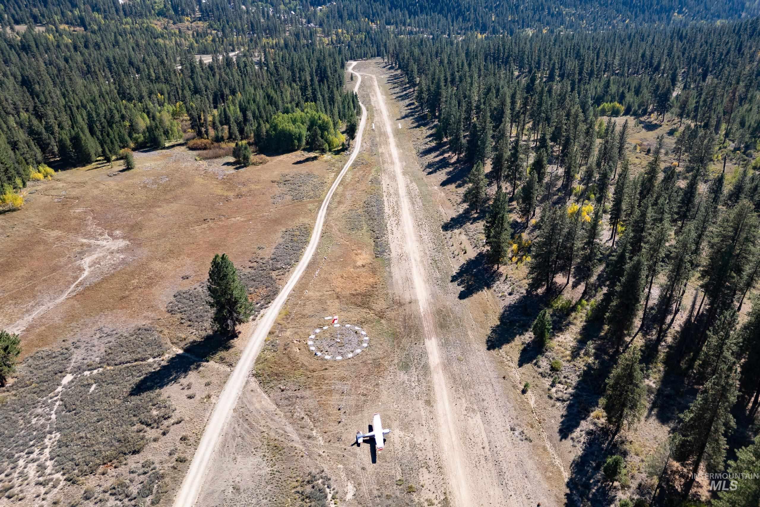 View of property location featuring a forest