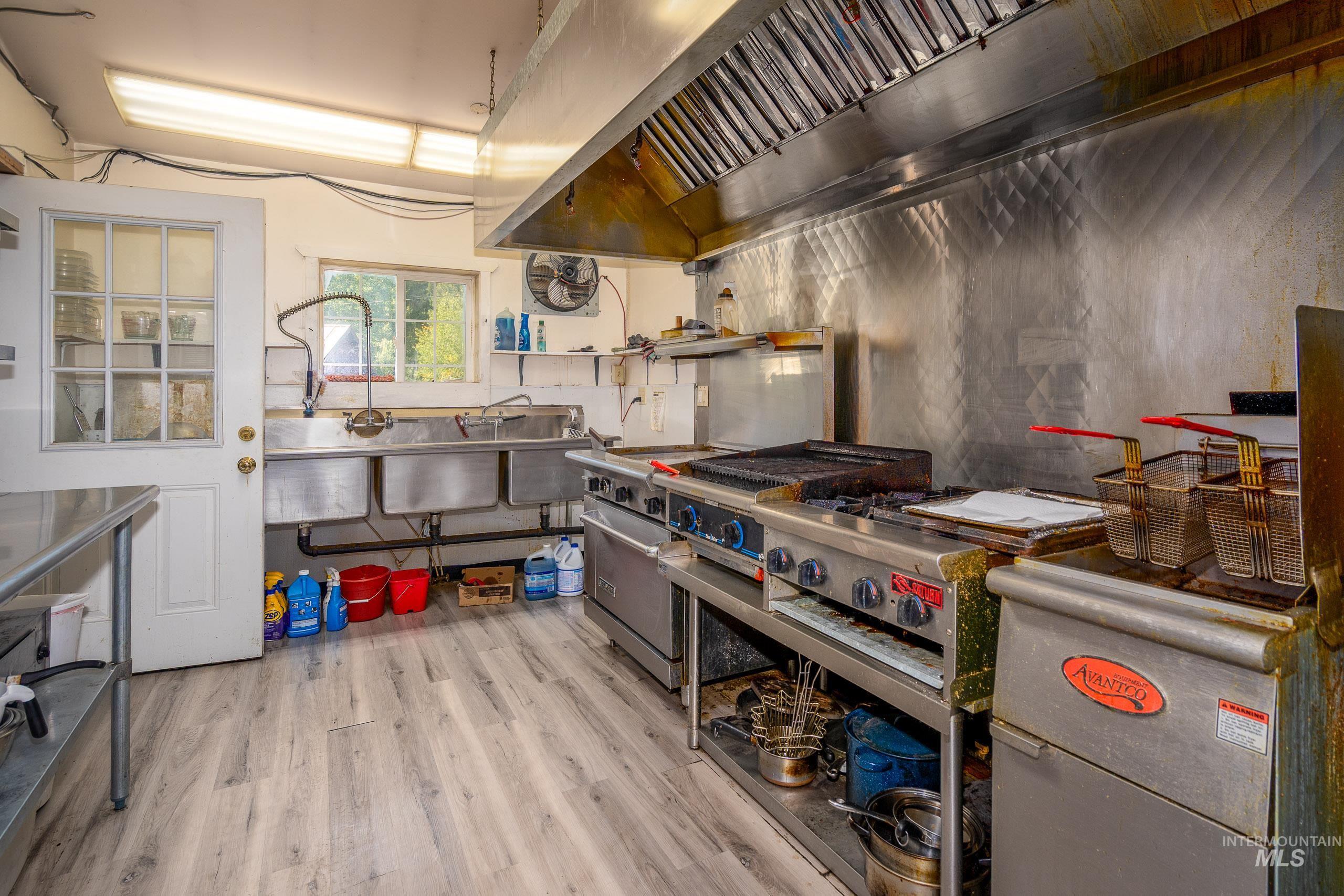 Kitchen with premium range hood and stainless steel range with gas cooktop