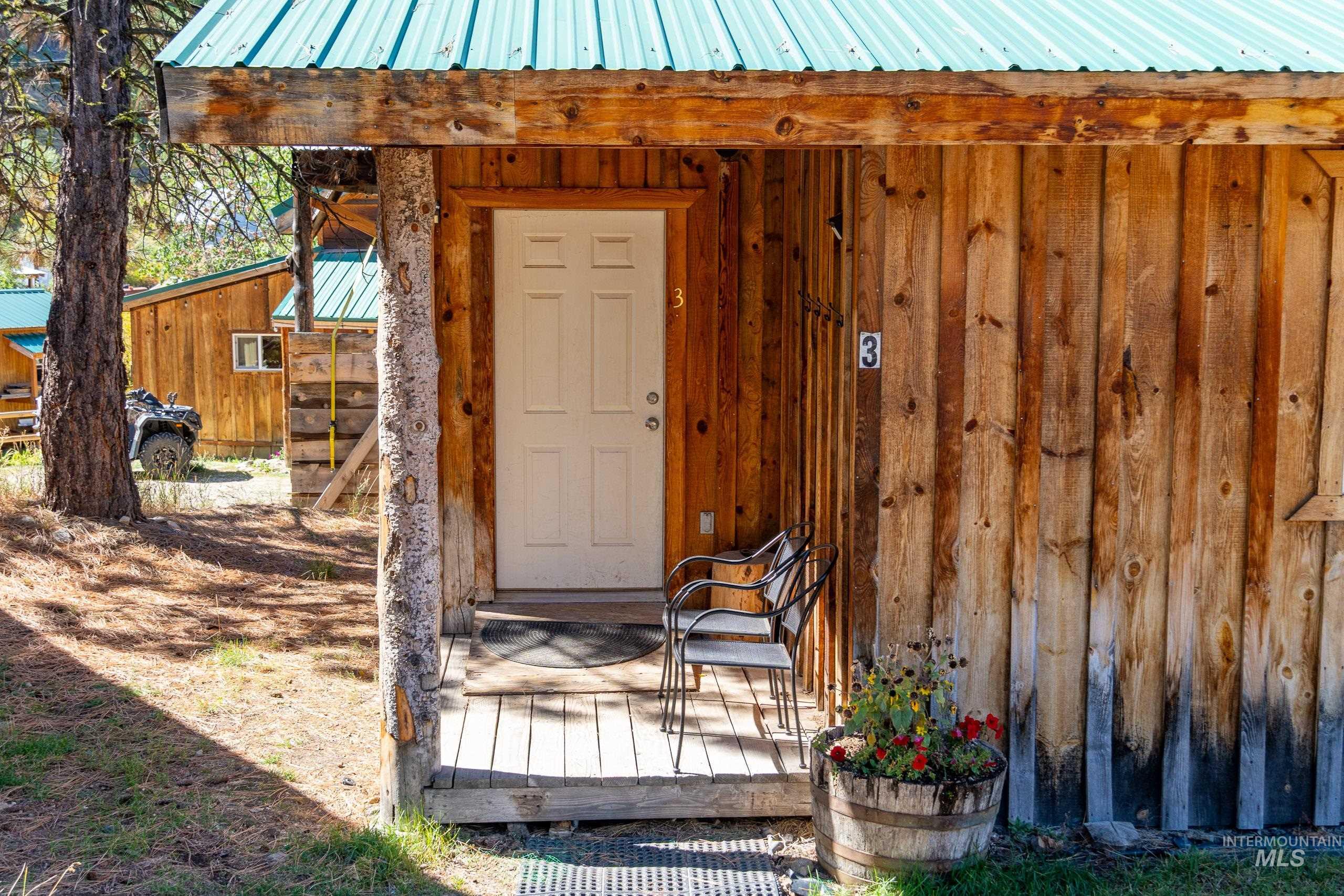 Doorway to property with a metal roof and board and batten siding