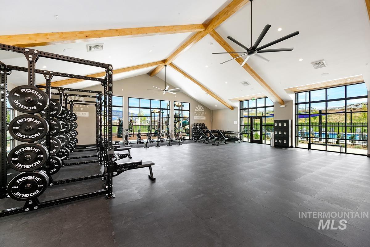 Exercise room with beamed ceiling, high vaulted ceiling, and recessed lighting